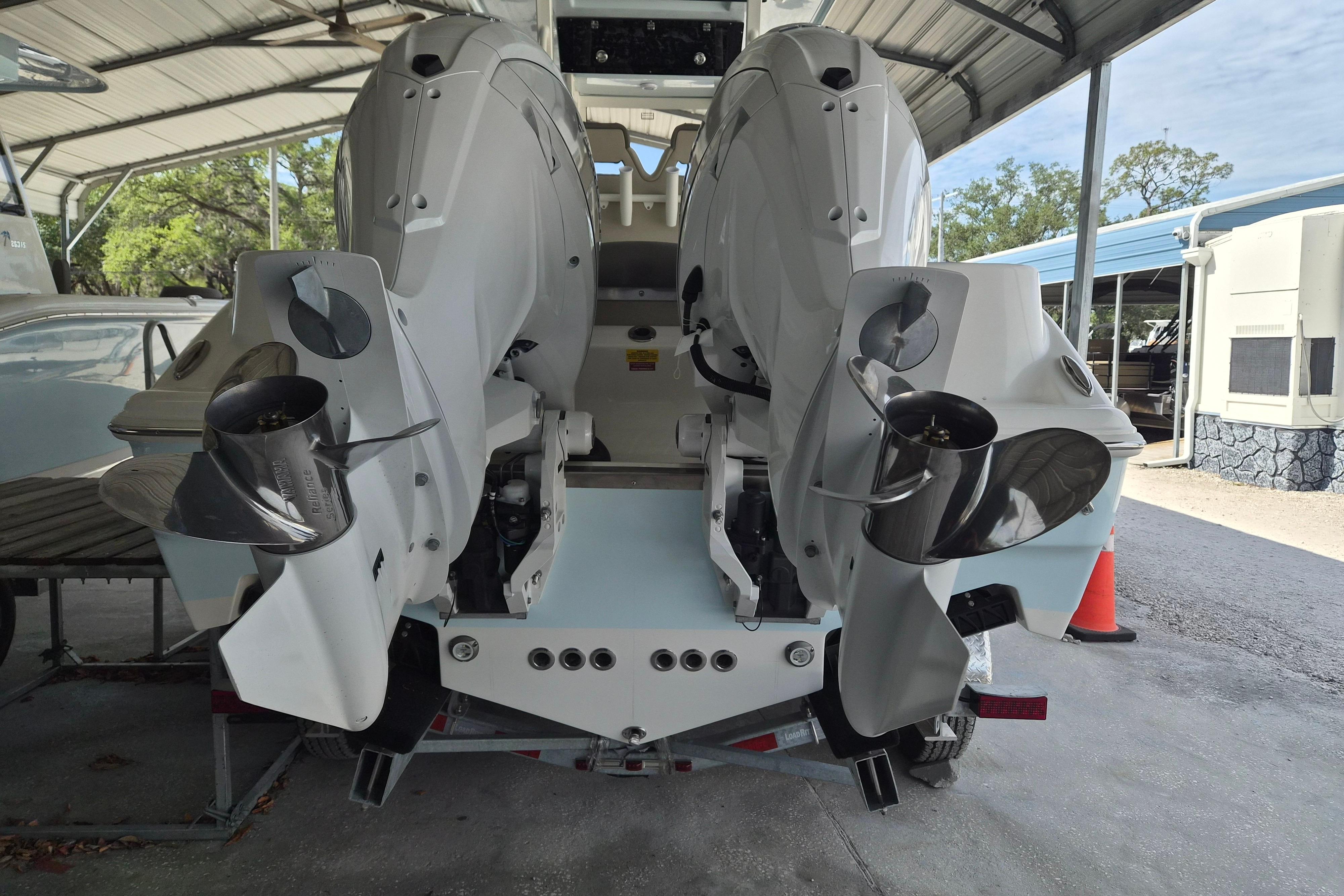 2026 Key West 260 Center Console boat with dual outboard engines in a covered storage area.