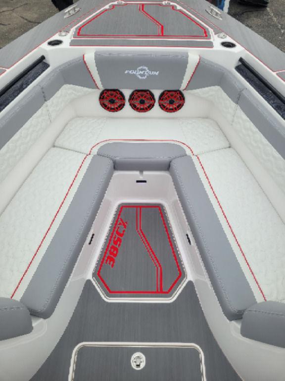 2024 Fountain 38 SCX boat interior with gray and red seating and speakers.