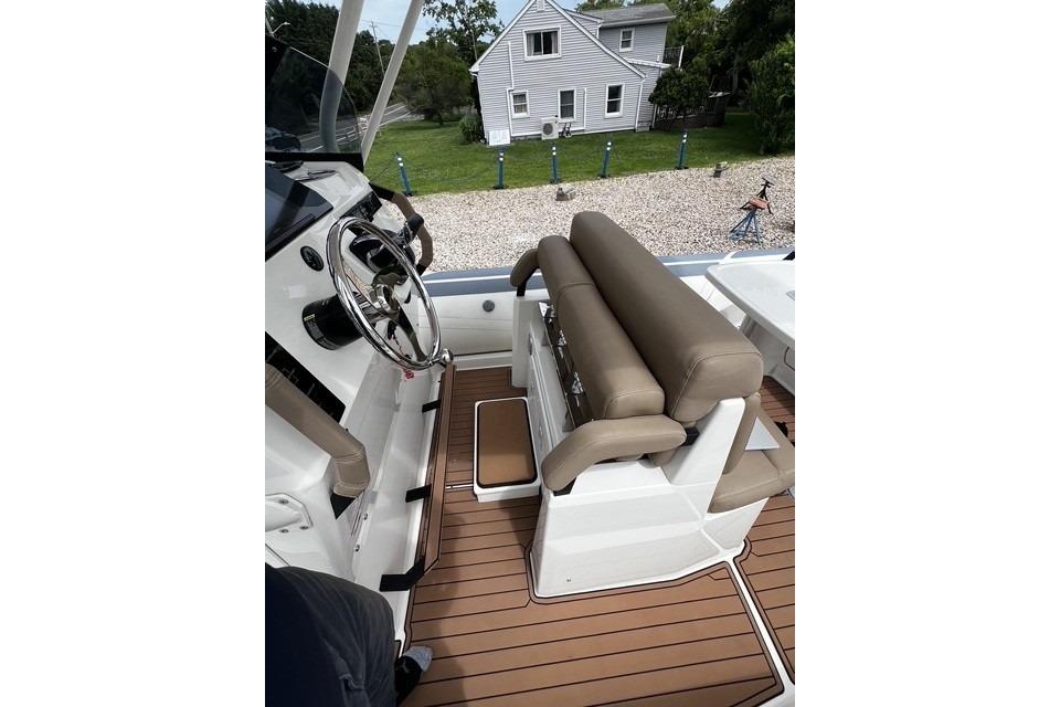 2022 Brig Eagle 8 boat interior with steering wheel and cushioned seating.