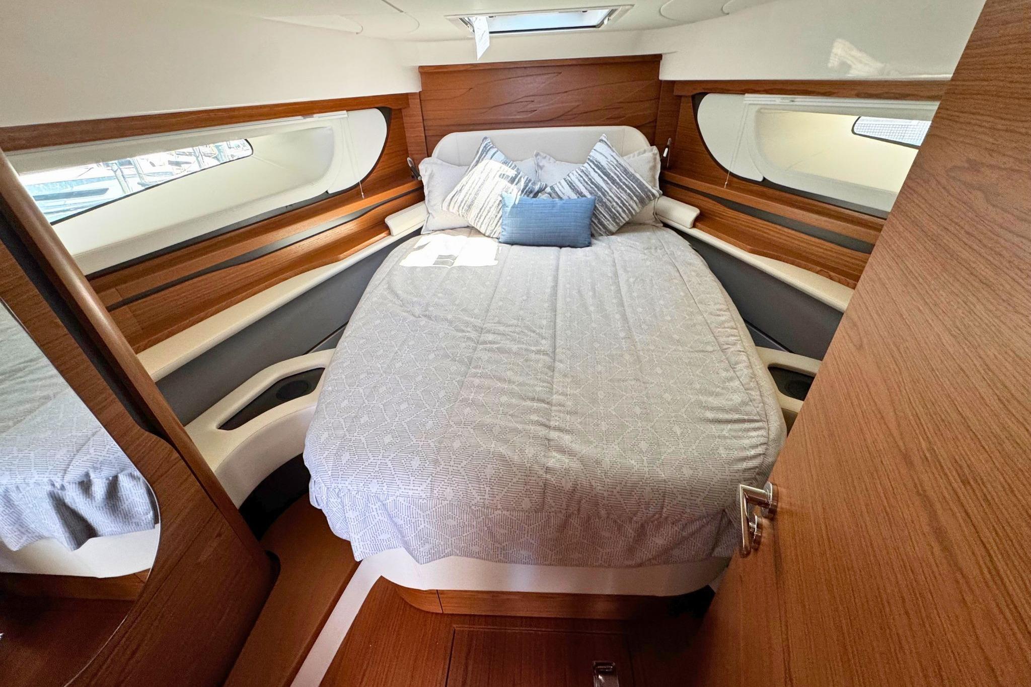Luxurious cabin interior of 2027 Tiara Yachts 39 LE with elegant bedding and wood accents.