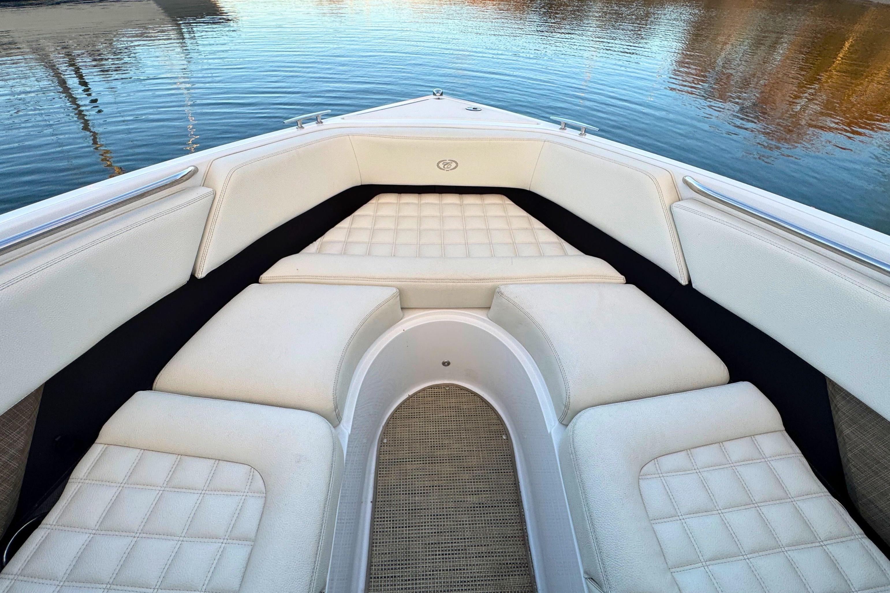 2019 Cobalt R3 boat interior with white cushioned seating on calm water.