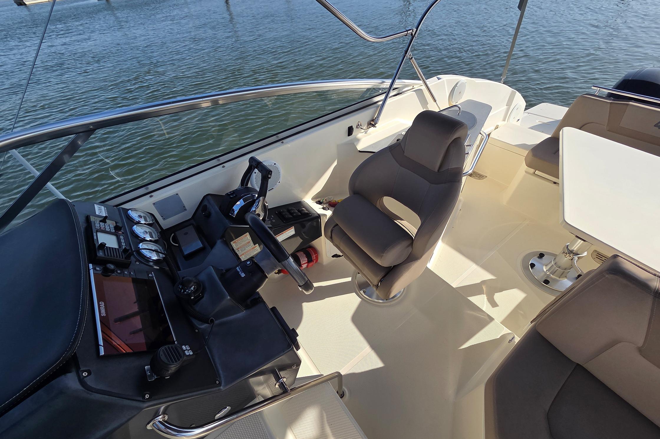 2017 Quicksilver Activ 805 Cruiser cockpit with steering wheel and seating.
