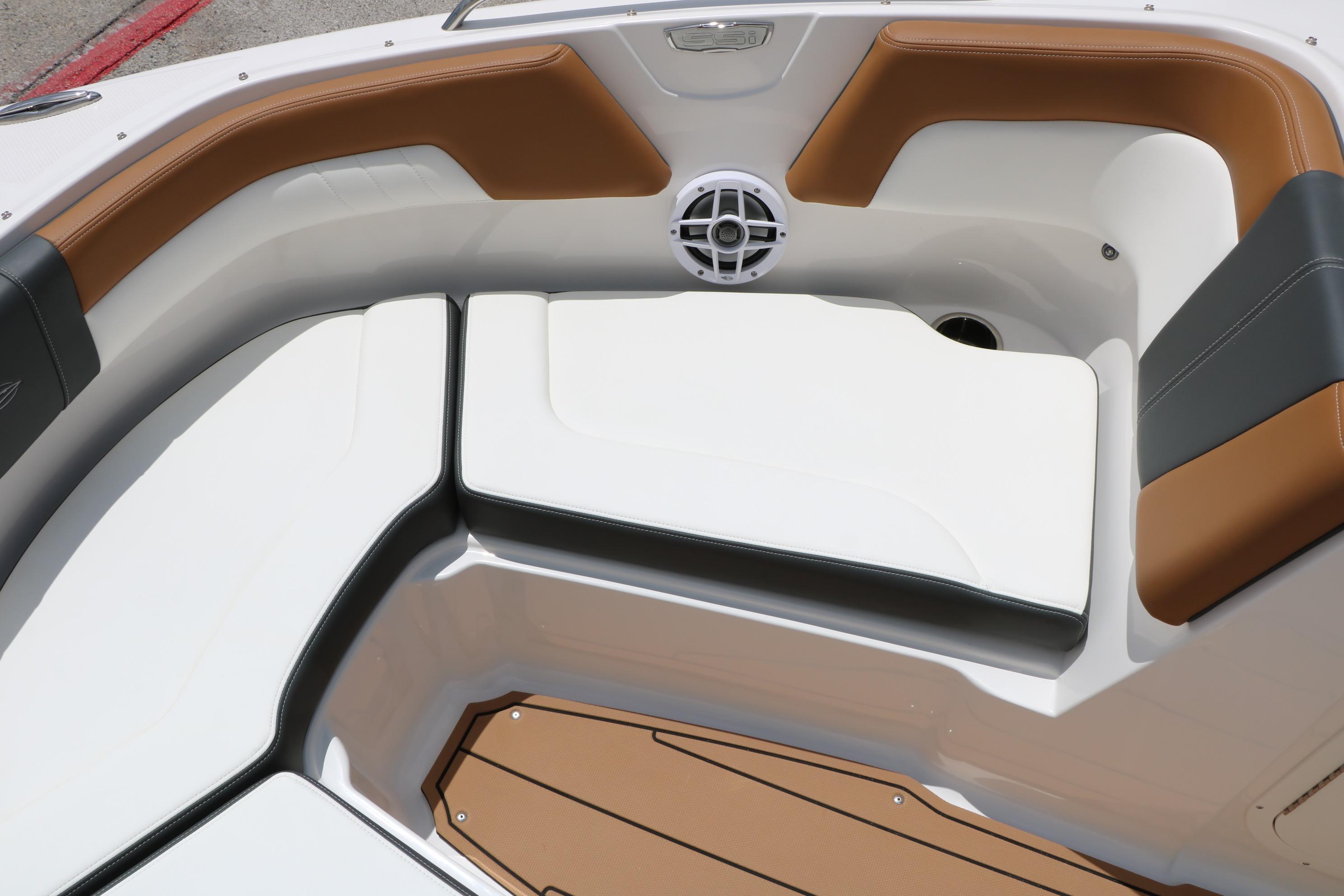 2025 Chaparral 23 SSi boat interior with cushioned seating and speaker system.