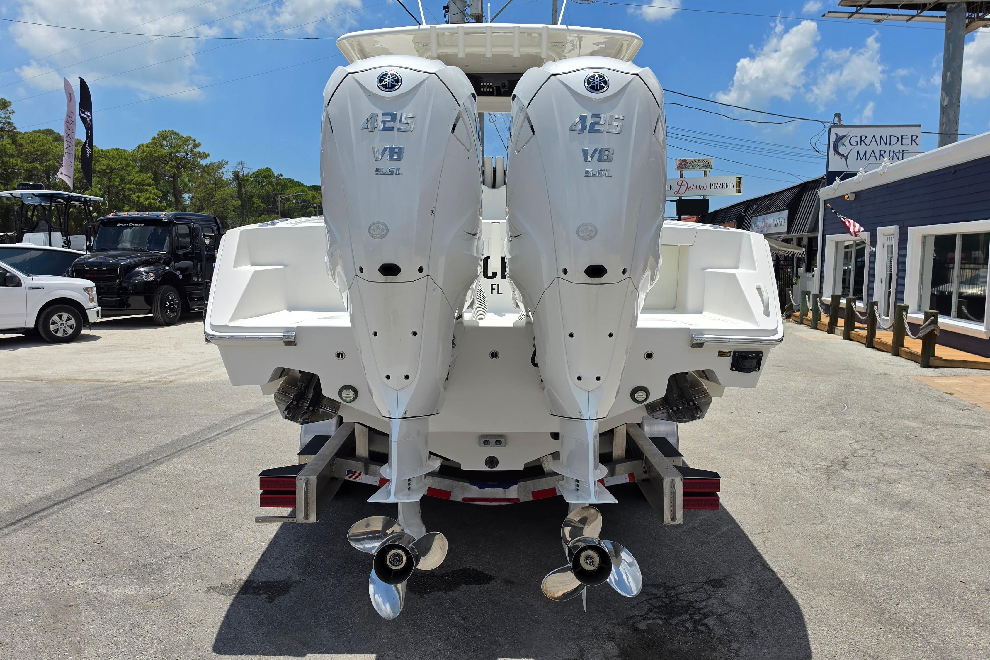 2020 Jupiter 34 HFS boat with twin Yamaha 425 V8 engines at a marina.