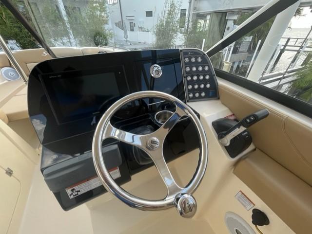 2019 Scout 255 Dorado boat helm with steering wheel and controls.