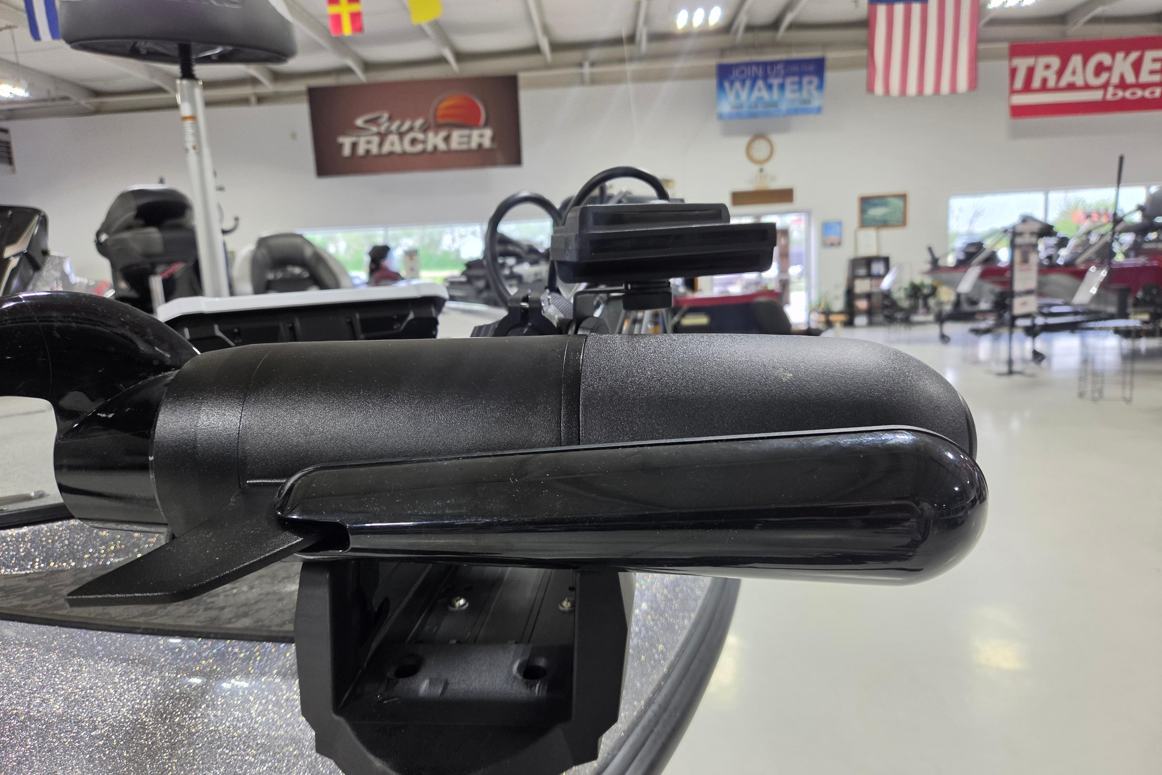 2026 Nitro Z19 XL boat motor in showroom with flags and banners.