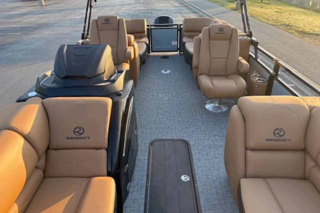 2026 Regency 230 DL pontoon boat interior with tan seating and modern design.