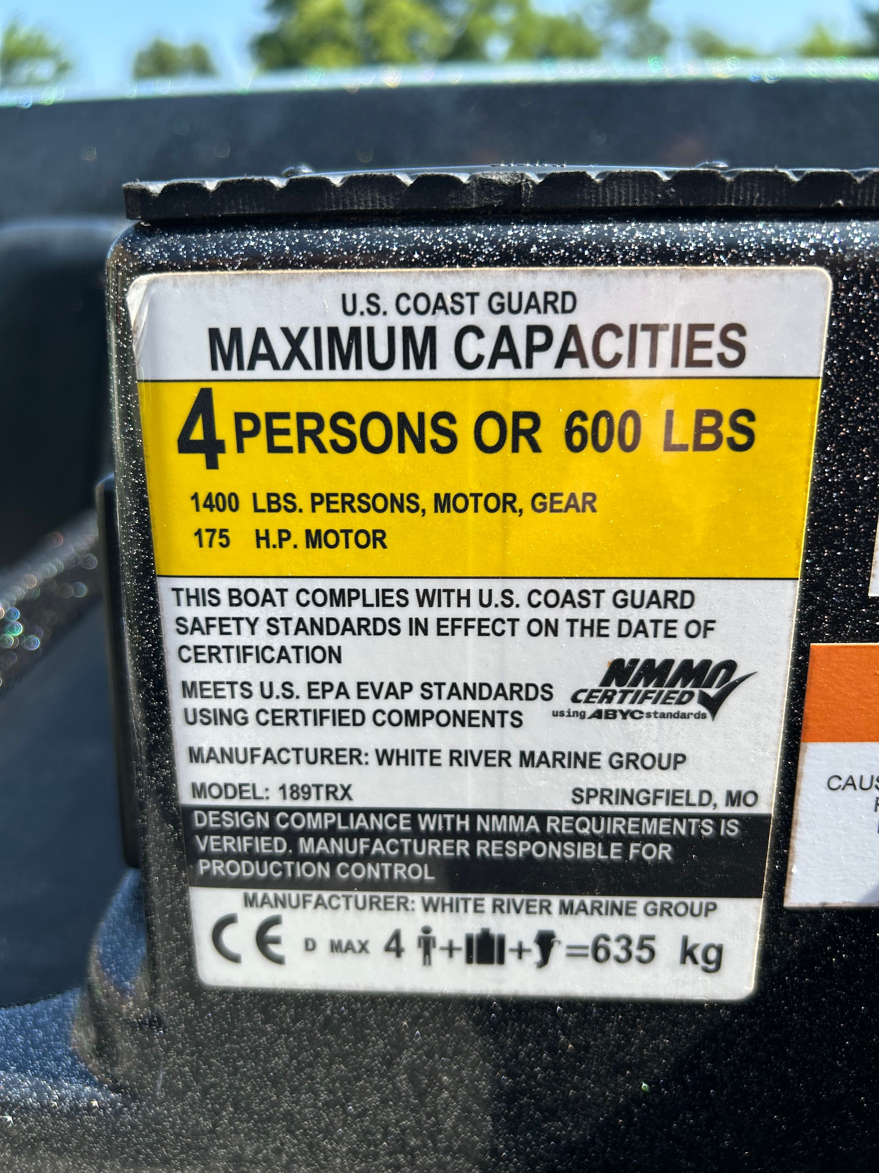 Sign shows maximum capacity: 4 persons or 600 pounds, 175 HP motor.
