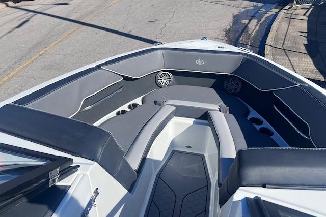 2025 Cobalt CS23 Surf boat interior with gray seating and speakers.