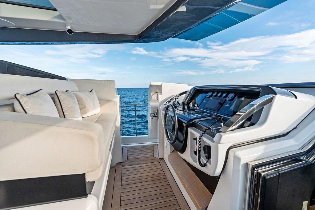 Luxurious 2018 Custom Line 120 yacht cockpit with plush seating and ocean view.