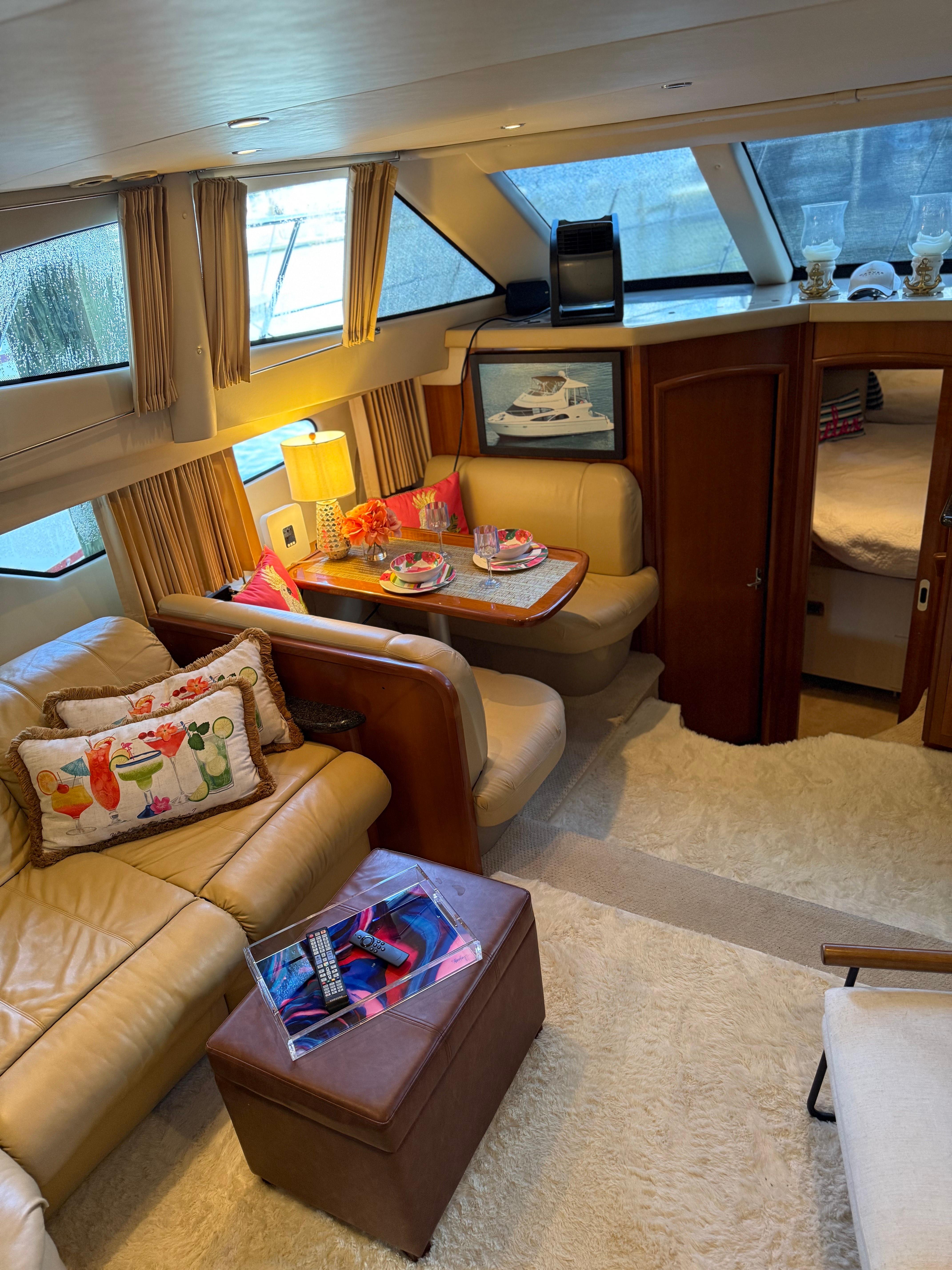 Luxurious interior of a 2006 Carver 41 Cockpit Motor Yacht with cozy seating and decor.