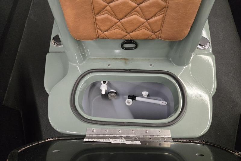 Avid 207 Recon 2026 boat seat with storage compartment open, showing interior details.