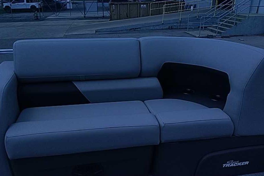 2026 Sun Tracker SportFish 22 DLX boat seating area with gray upholstery.