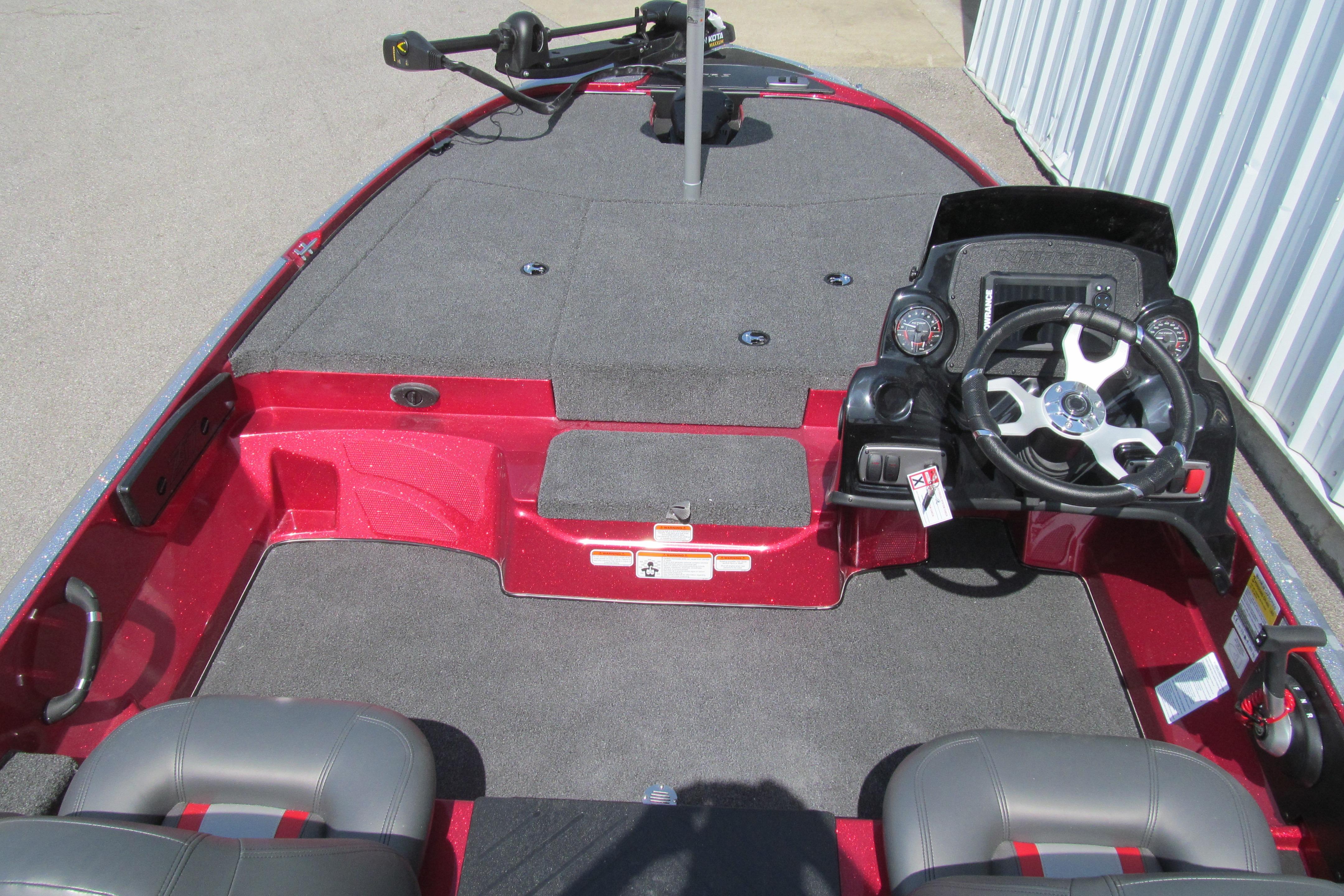 2026 Nitro Z17 boat interior with steering wheel and seating, featuring a sleek red design.