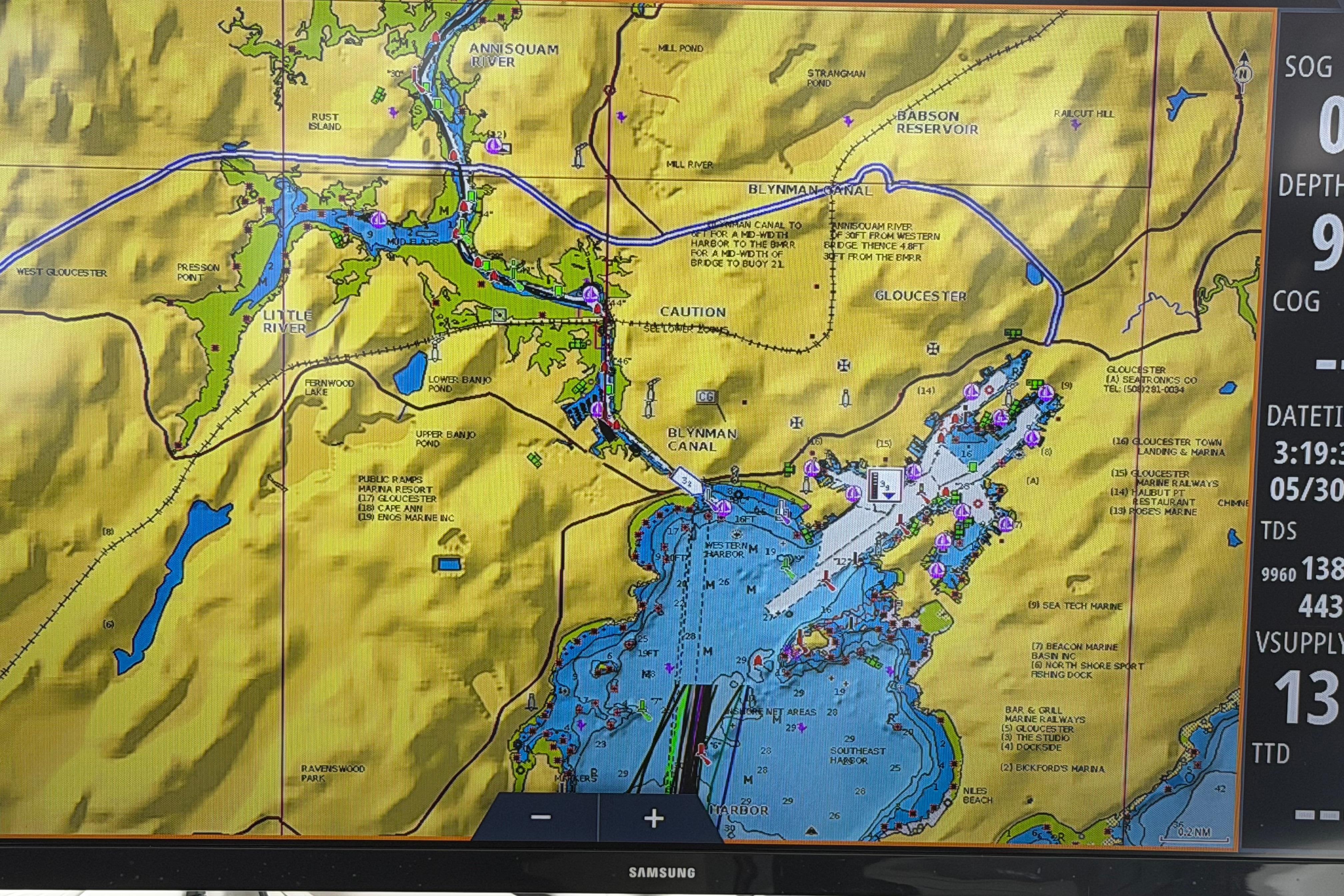 Marine navigation chart on a Samsung display, featuring Gloucester waterways and landmarks.