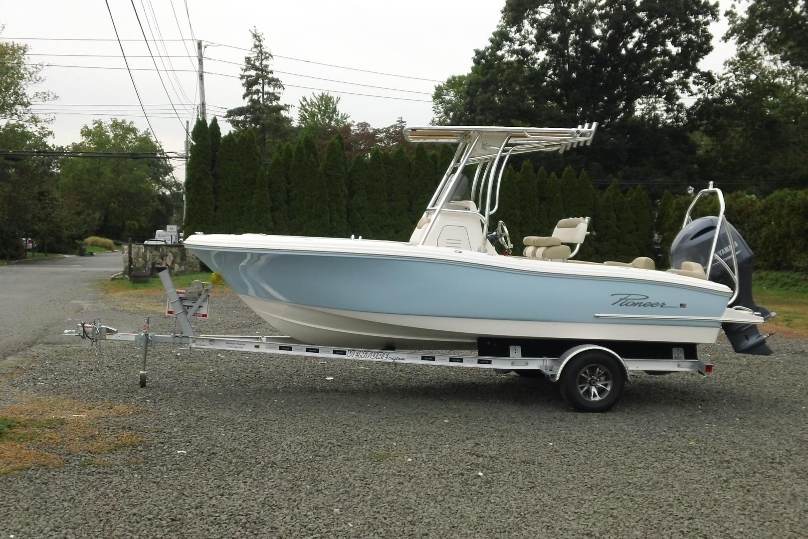 2026 Pioneer 202 Islander boat on trailer, parked outdoors, side view.