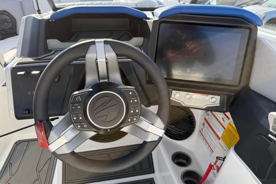 2026 Tigé Z3 boat dashboard with steering wheel and touchscreen display.