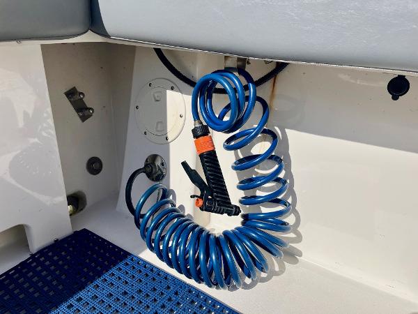 Coiled blue hose in 2023 Defiance Admiral 220 EX boat interior.