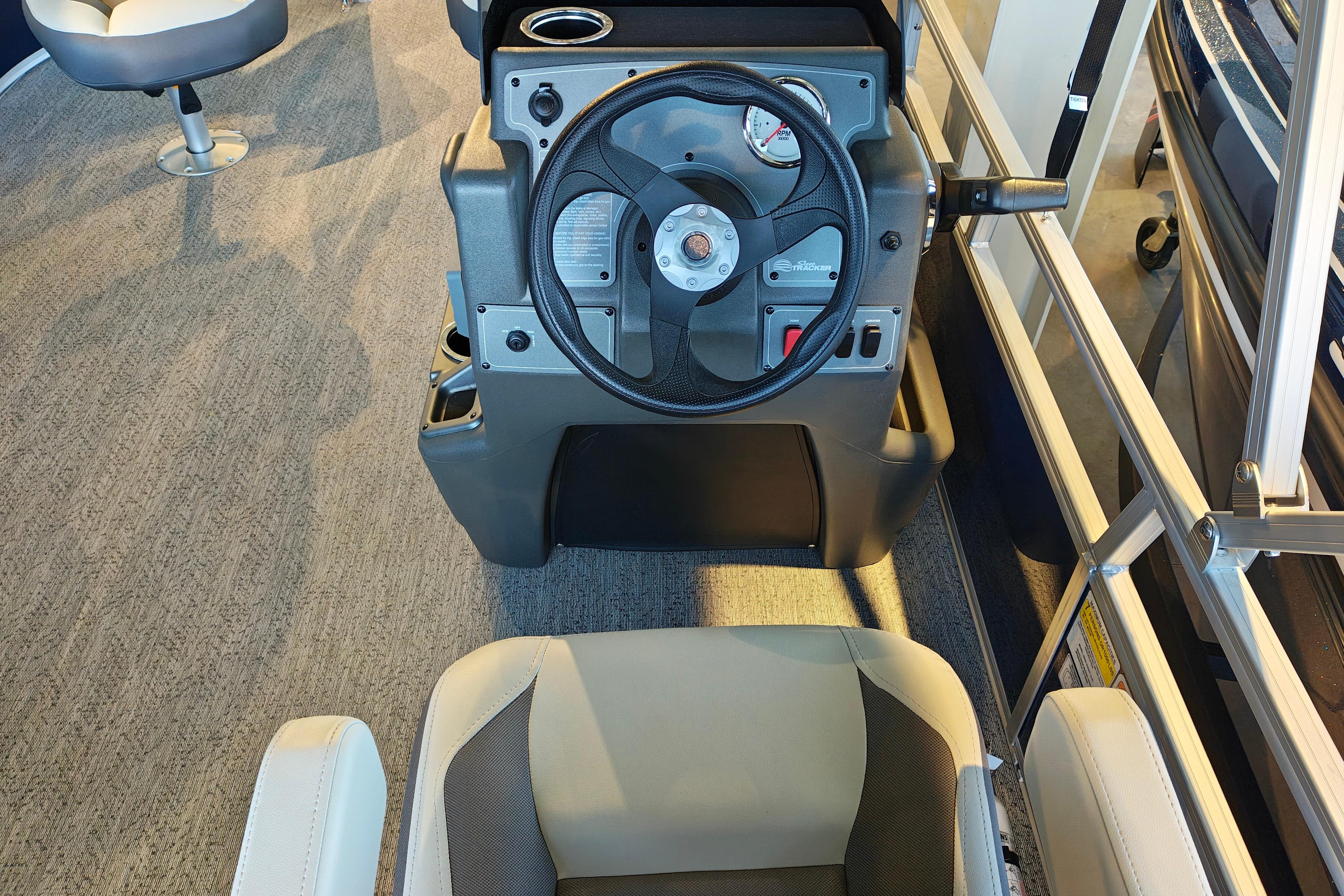 2026 Sun Tracker Bass Buggy 16 XL Select boat interior with steering wheel and seating.