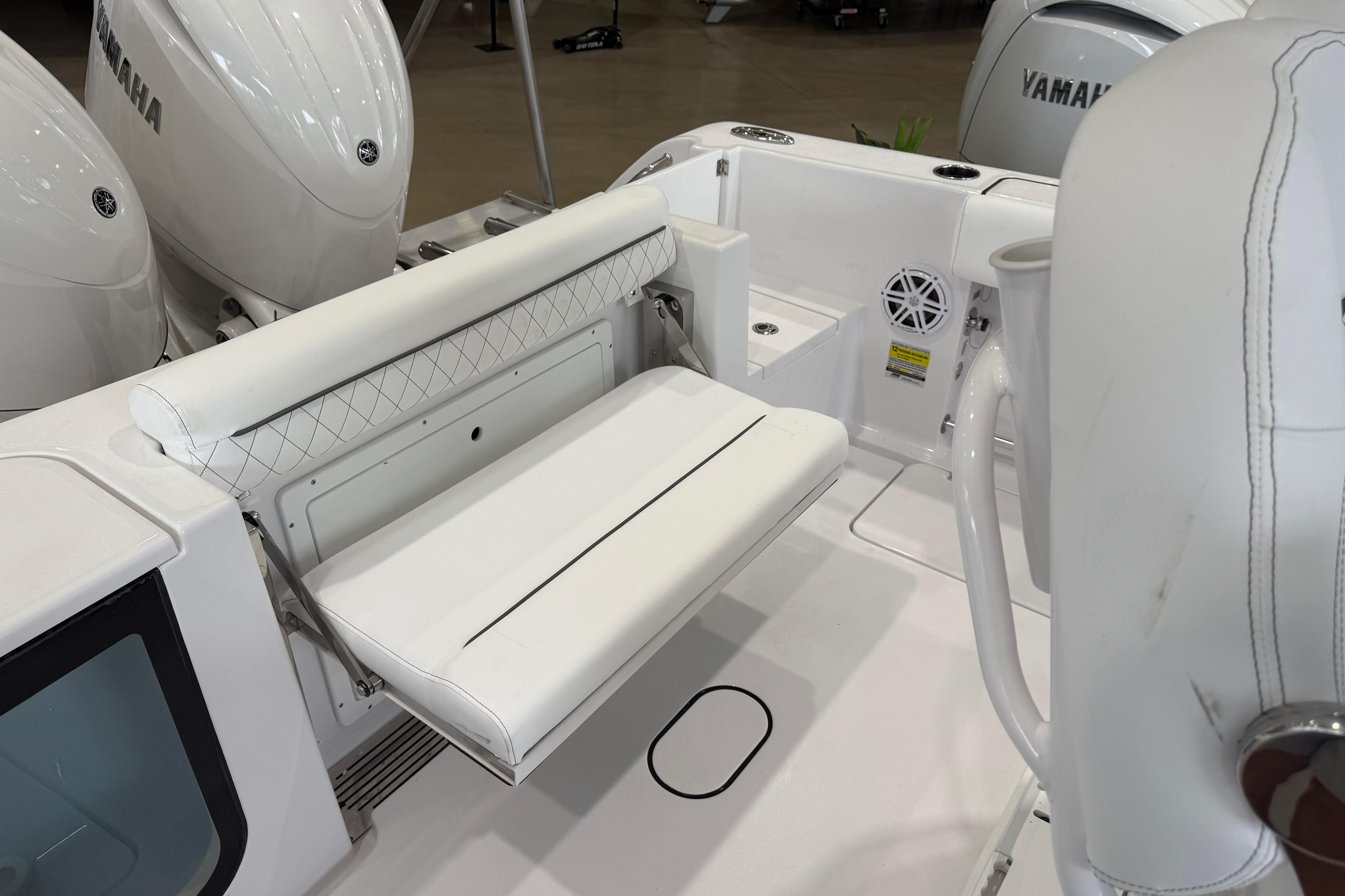 2026 Sportsman Open 252 Center Console boat interior with white seating and Yamaha engines.