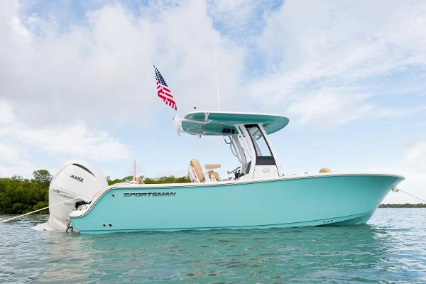 Manufacturer Provided Image: 2025 Sportsman Heritage 231 Center Console boat on water, American flag, clear sky.