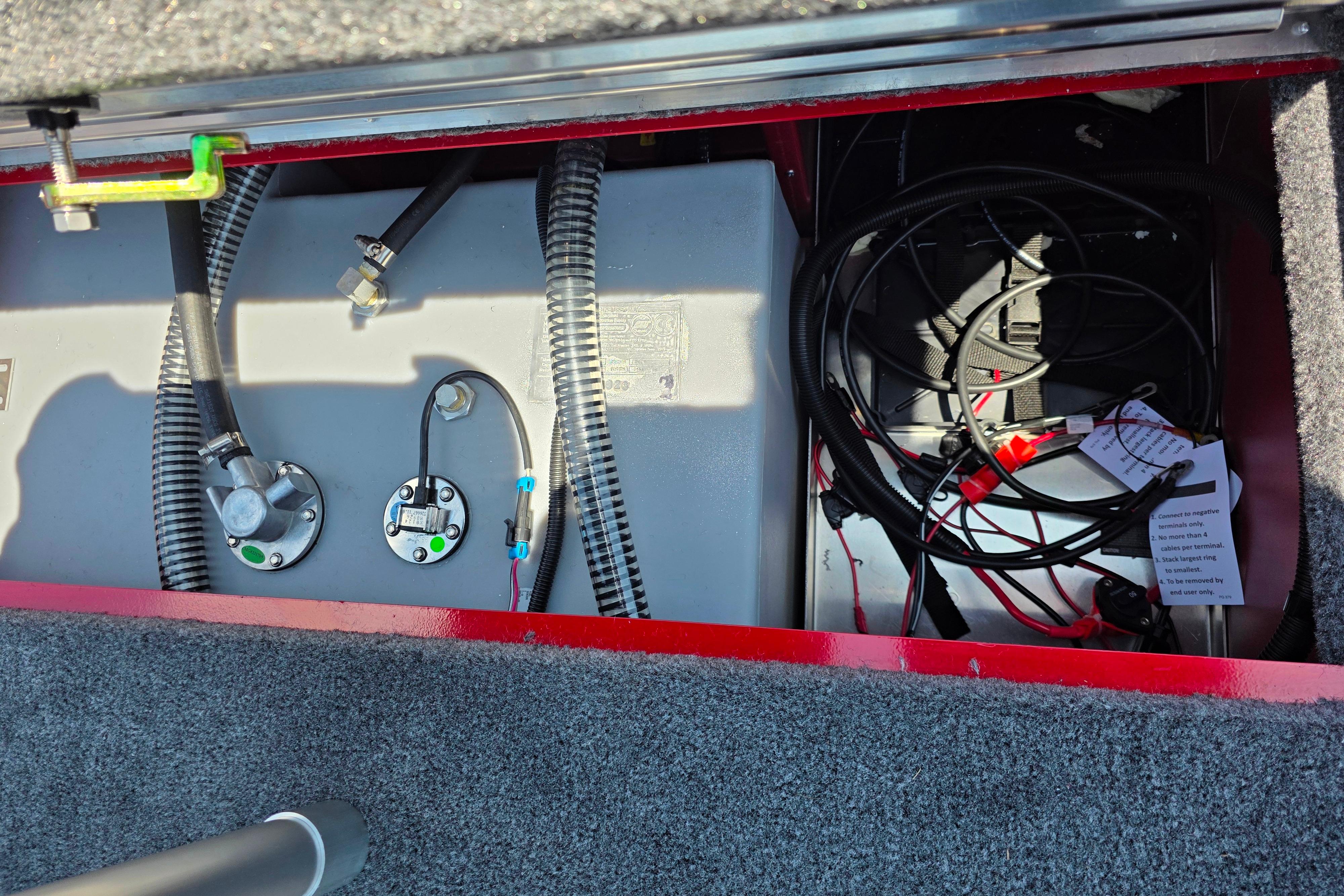 Open compartment of 2026 Tracker Pro Team 195 boat showing wiring and components.