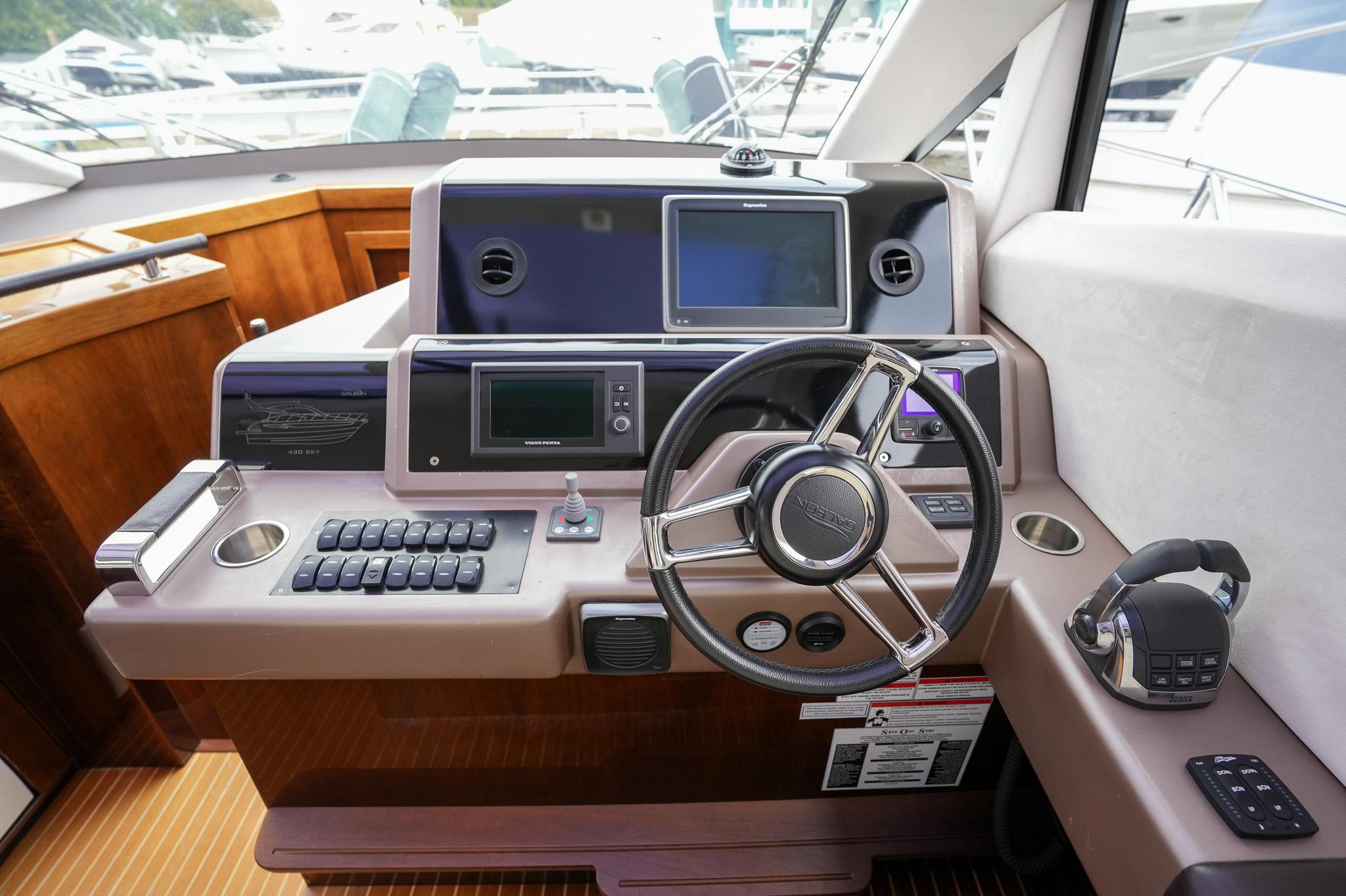Helm of 2017 Galeon 43 SKY yacht with modern navigation equipment.