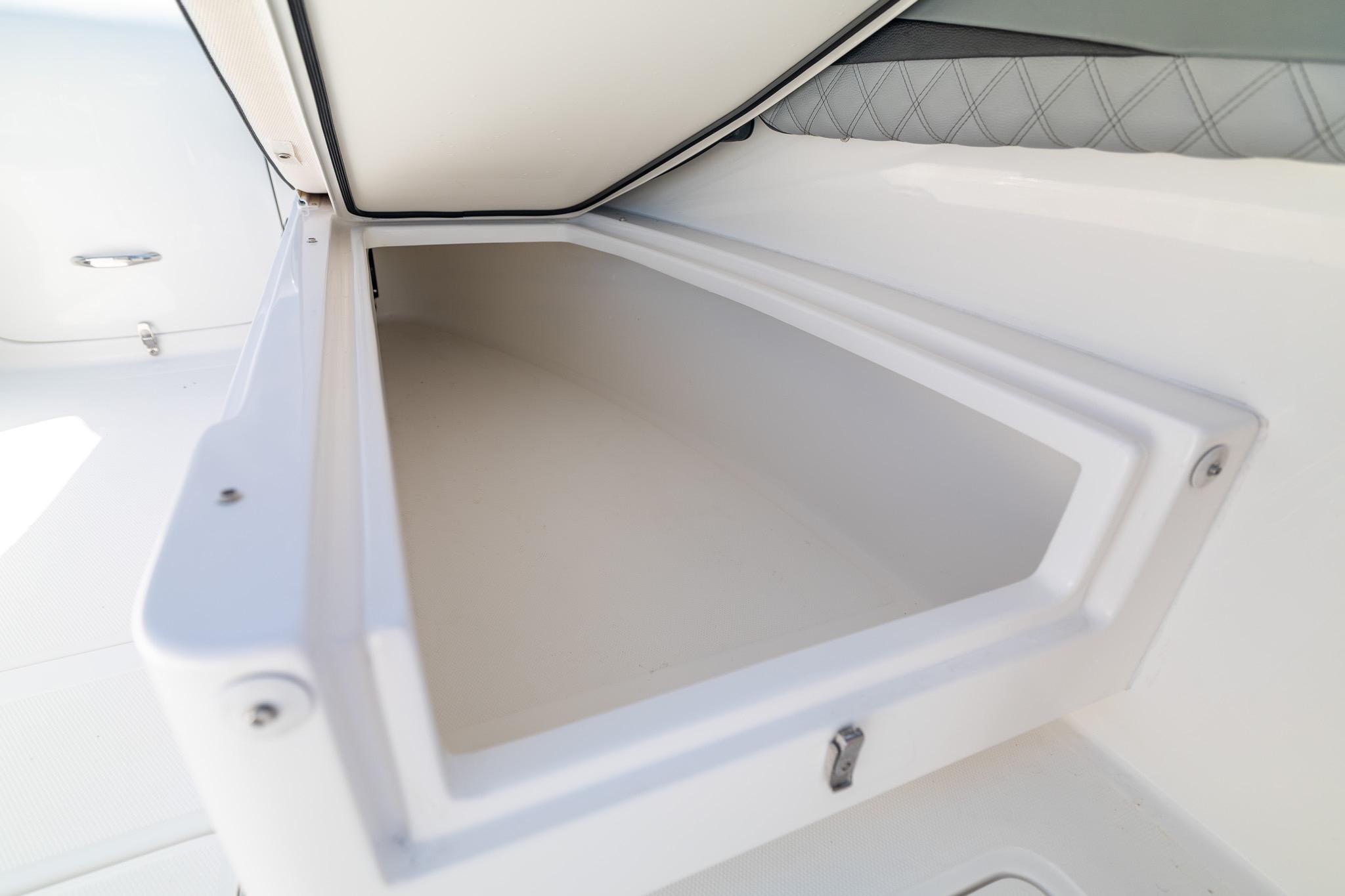 Storage compartment on a 2019 Deep Impact 369 Sport boat, featuring sleek white interior design.
