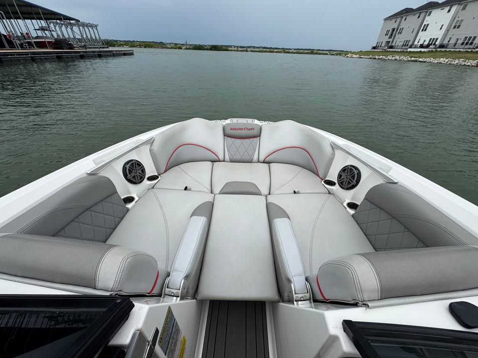 Interior view of a 2015 MasterCraft X46 boat on a lake.