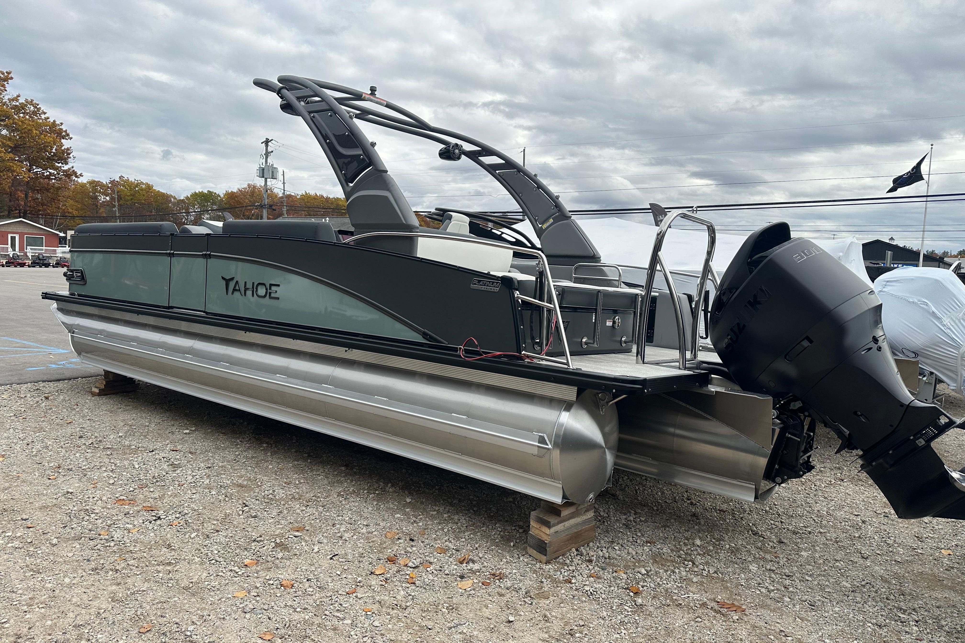 2026 Tahoe Pontoon Cascade 24' boat with sleek design and powerful outboard motor.