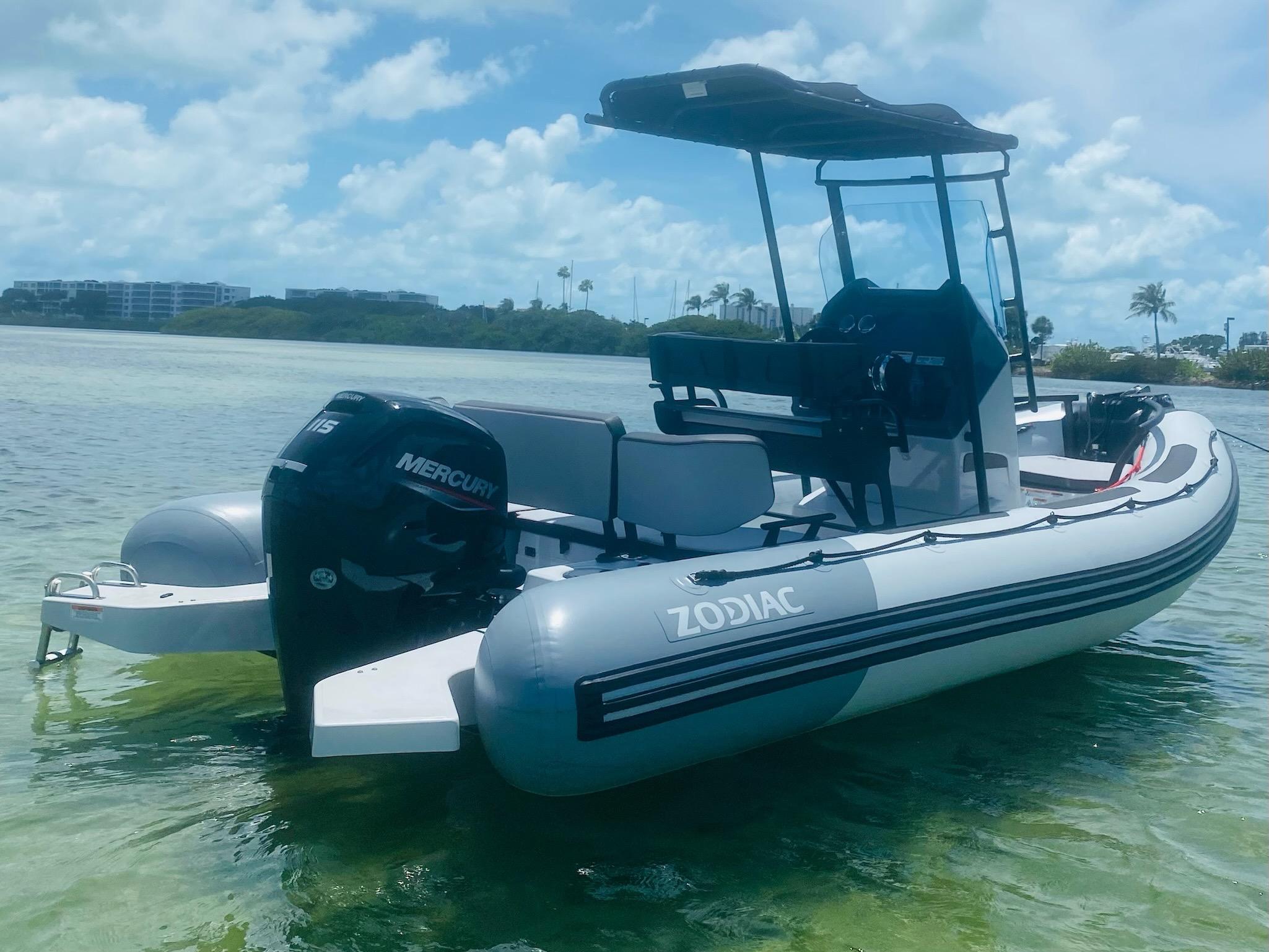 2024 Zodiac Open 5.5 inflatable boat with Mercury outboard motor on clear water.