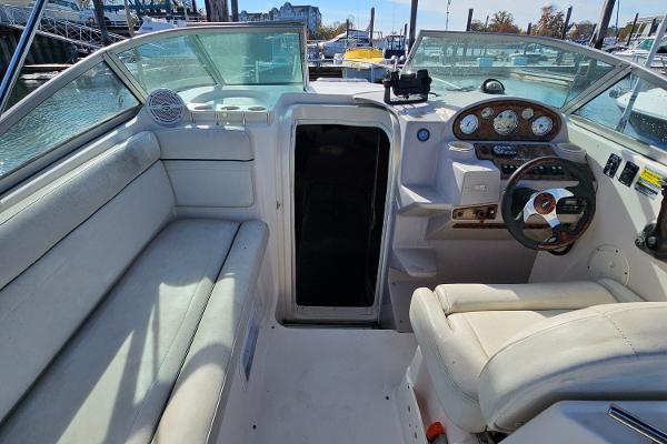 2004 Rinker Fiesta Vee 250 boat interior with steering wheel and seating area.