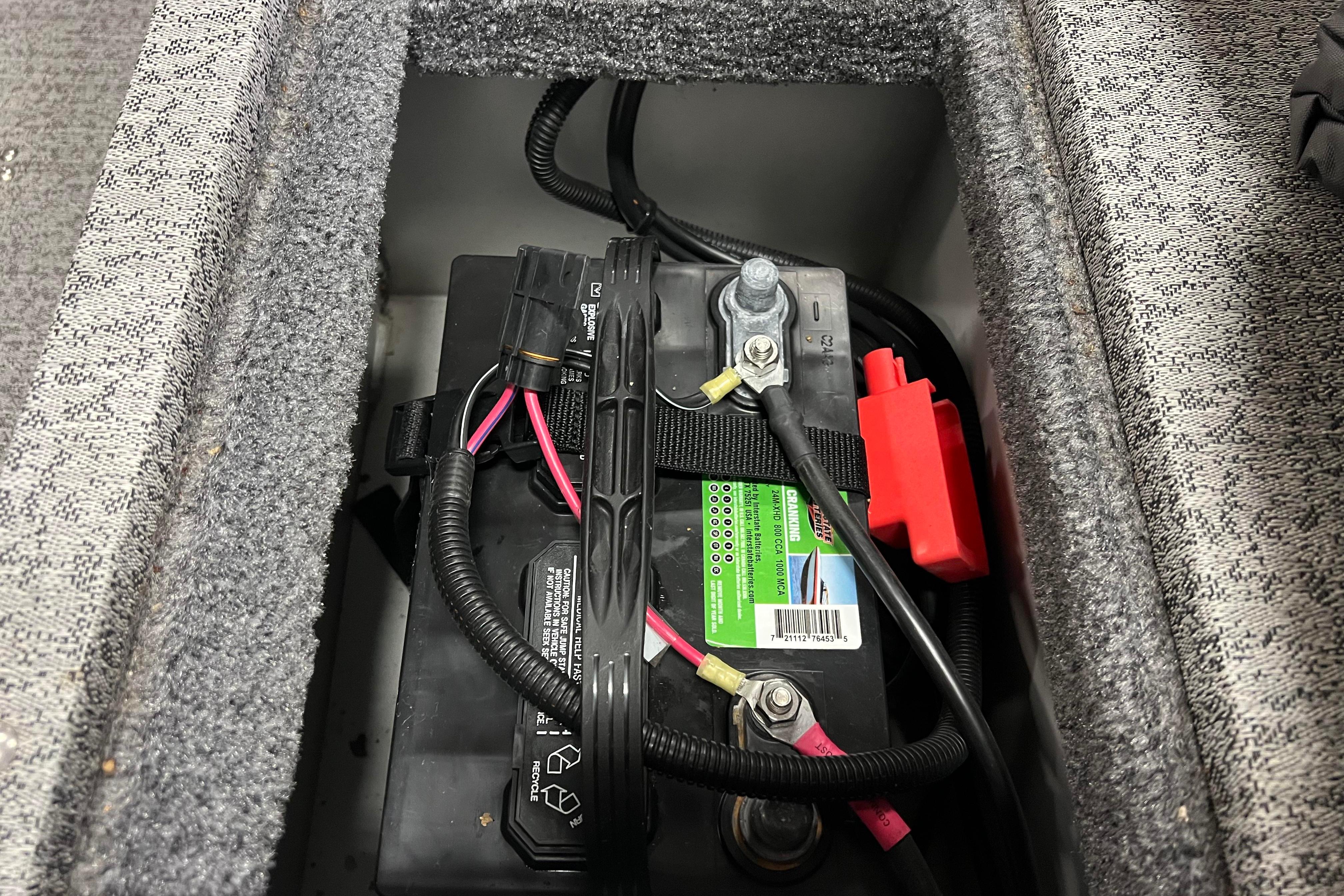 Battery compartment of 2022 Tracker Pro Guide V-16 WT boat, showing wiring and connections.