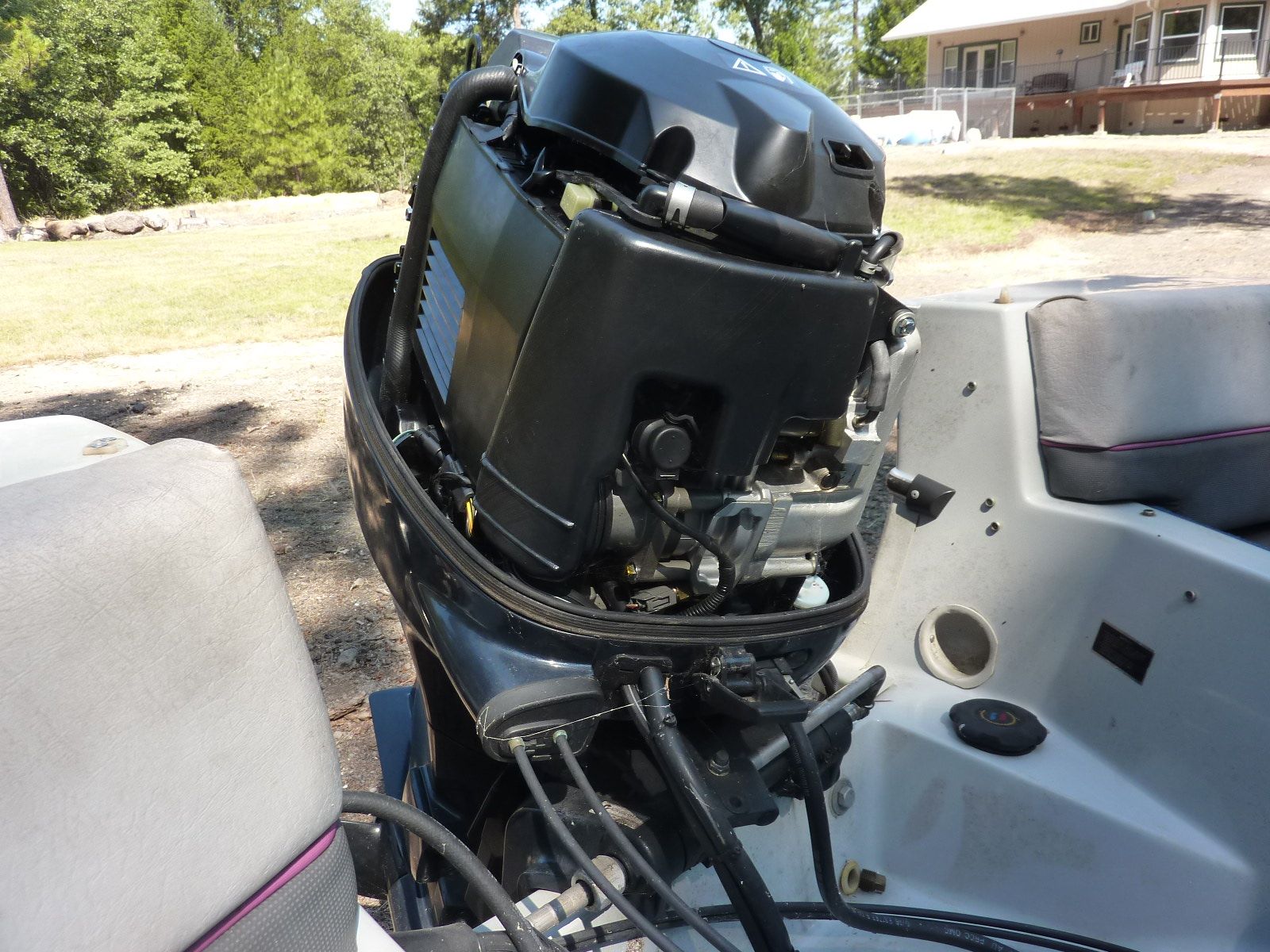 A 1989 Bayliner CAPRI with an outboard motor, parked on dry land.
