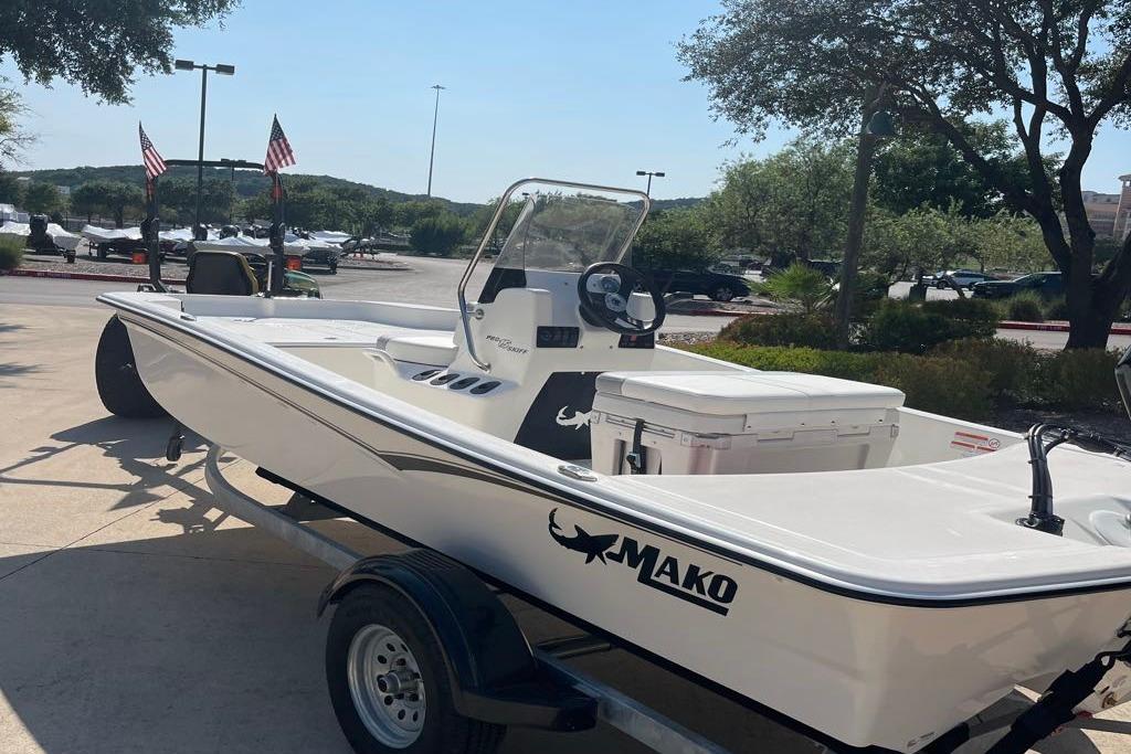 2026 Mako Pro Skiff 15 CC boat on trailer in sunny outdoor setting.