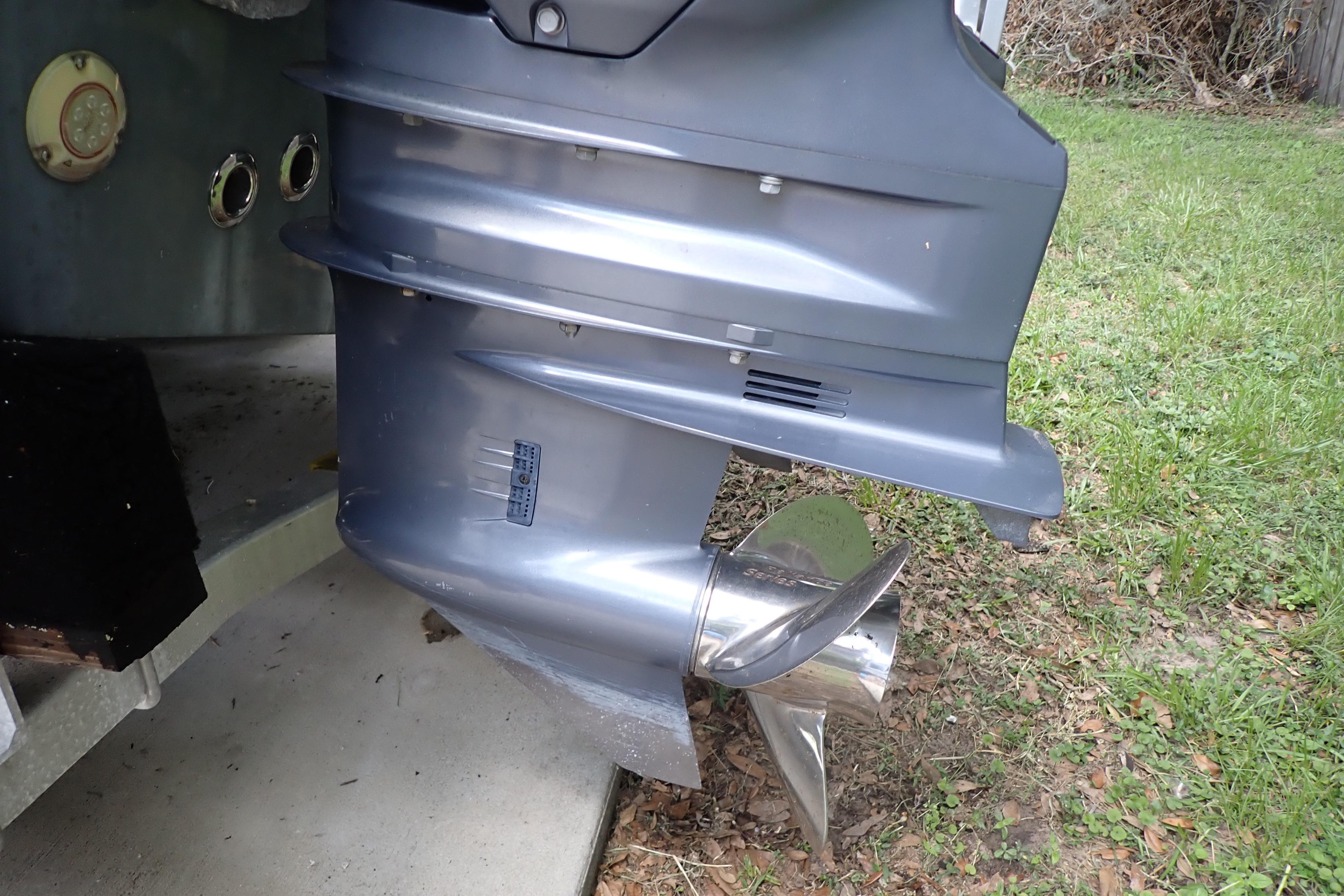 Close-up of a 2019 Key West 263 FS boat propeller on grass.