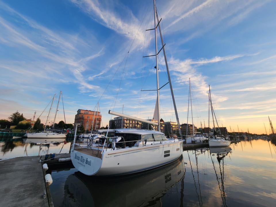 Sailboats docked at sunset, featuring a 2025 Moody 48 DS yacht.
