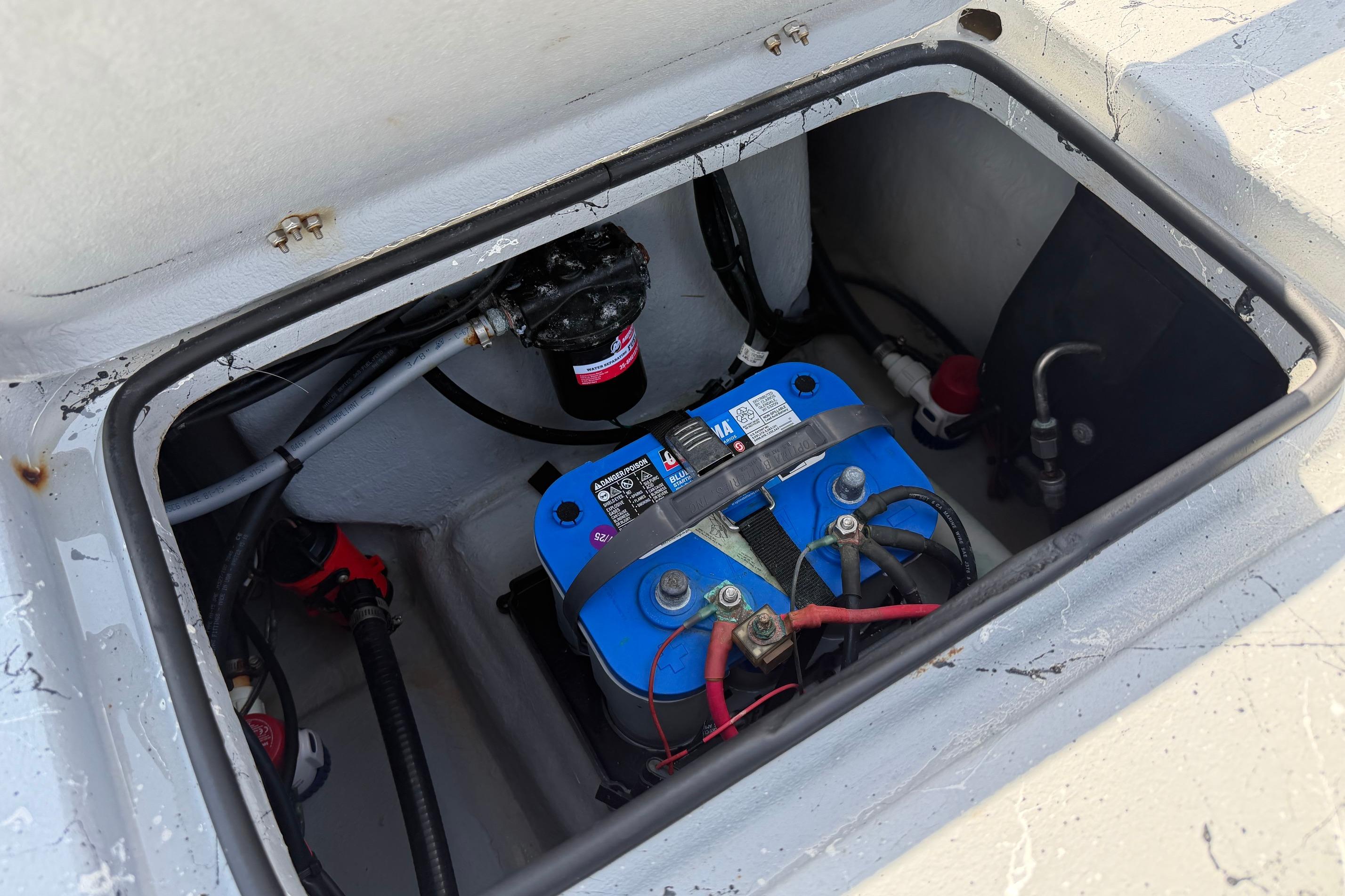 Battery compartment of 2023 Haynie 23 Super Cat boat, featuring wiring and components.