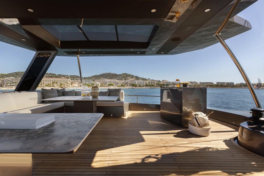 Luxurious 2026 Moon 60 Sail yacht deck with modern seating and ocean view.