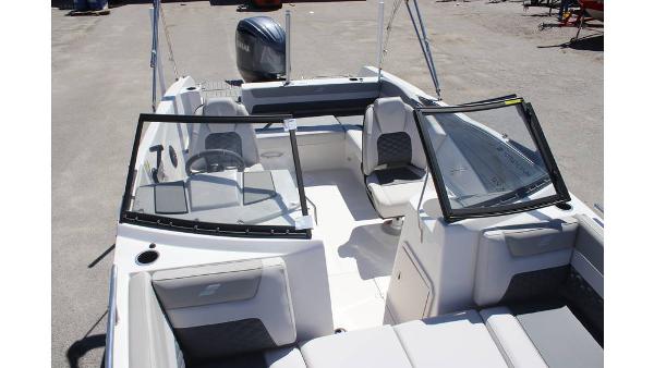 2025 Starcraft SVX 210 OB DC boat interior with seating and steering wheel.