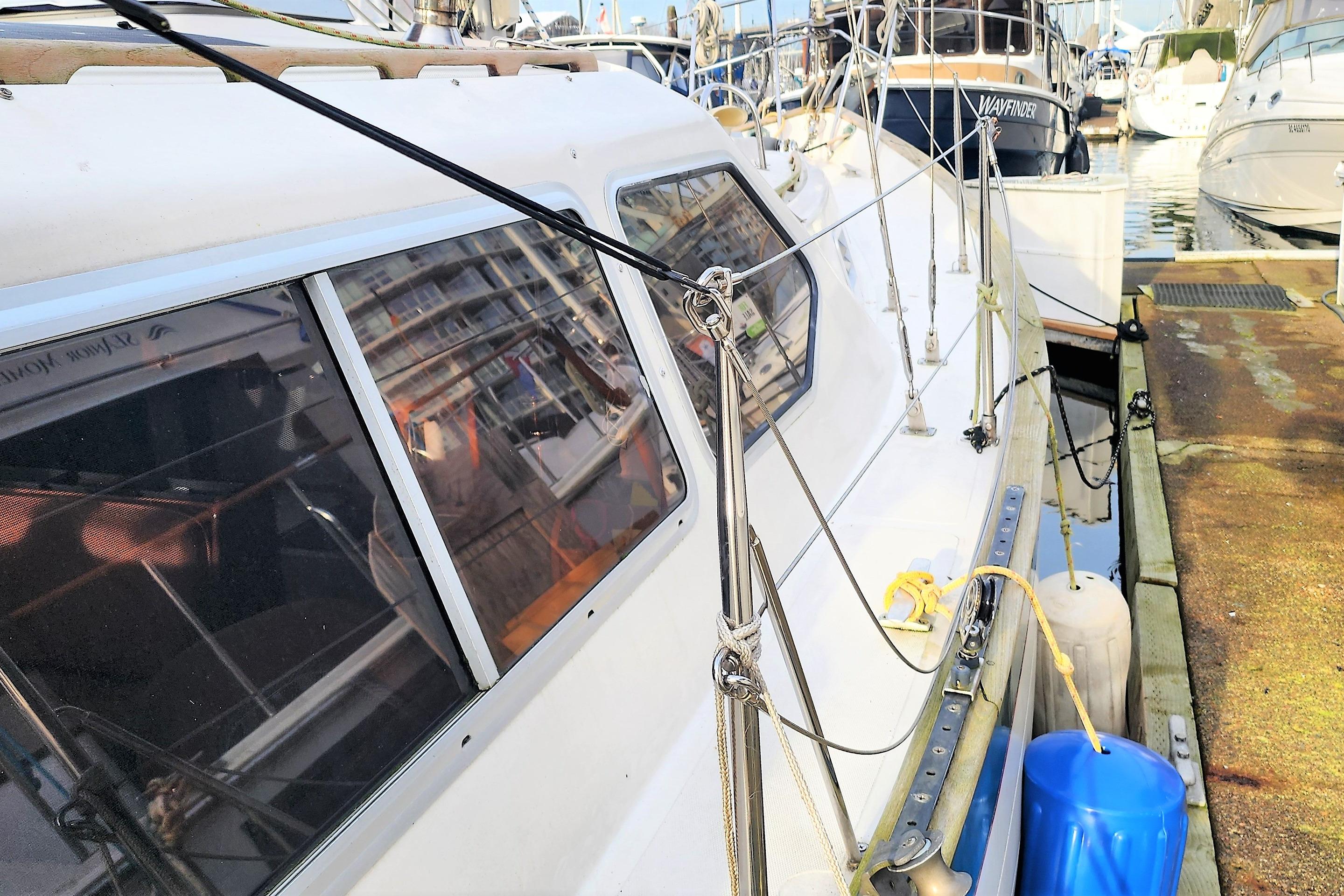 1986 Saturna 33 Pilot sailboat docked at marina, side view with rigging details.