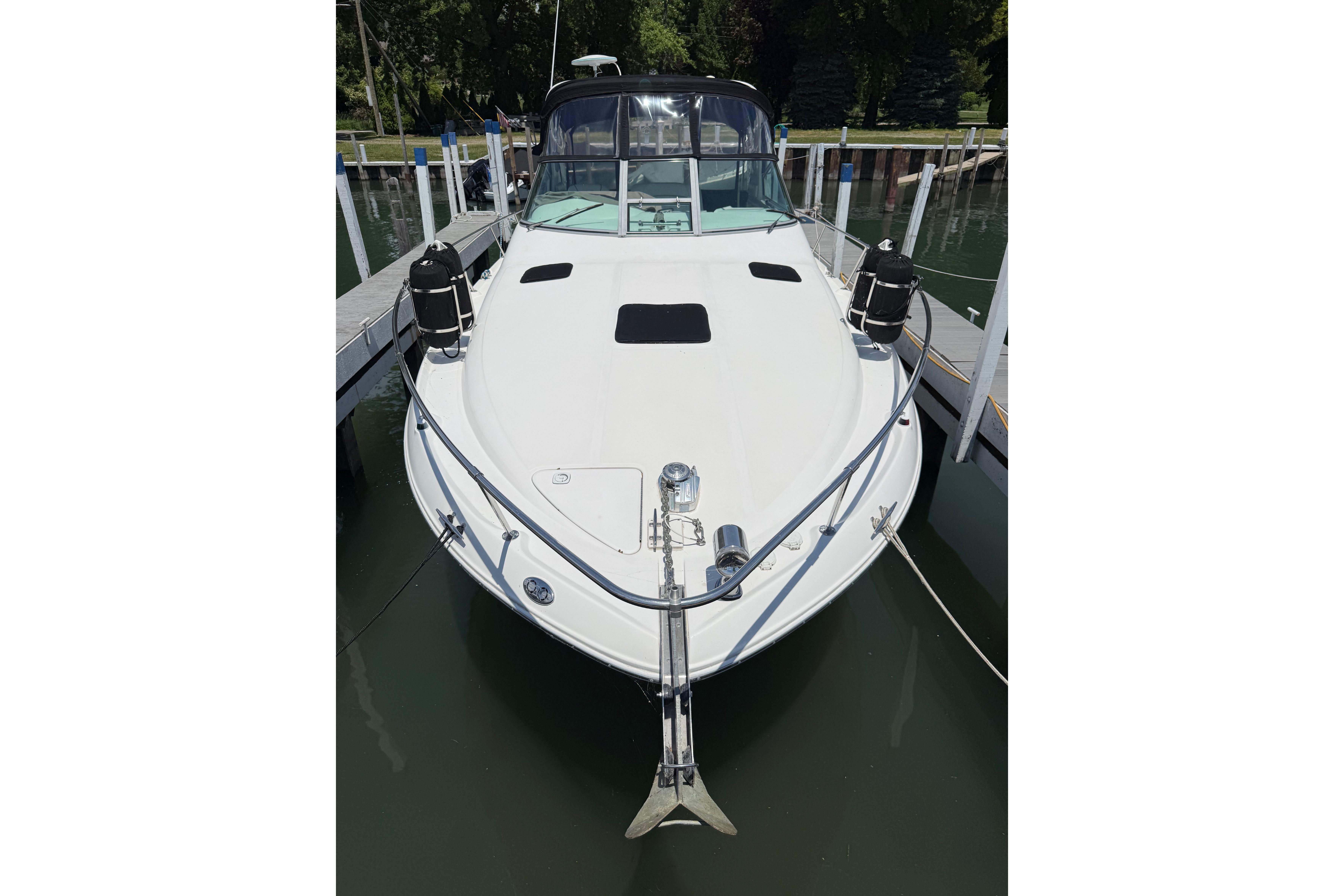 1999 Sea Ray Sundancer 310 docked at marina, front view.