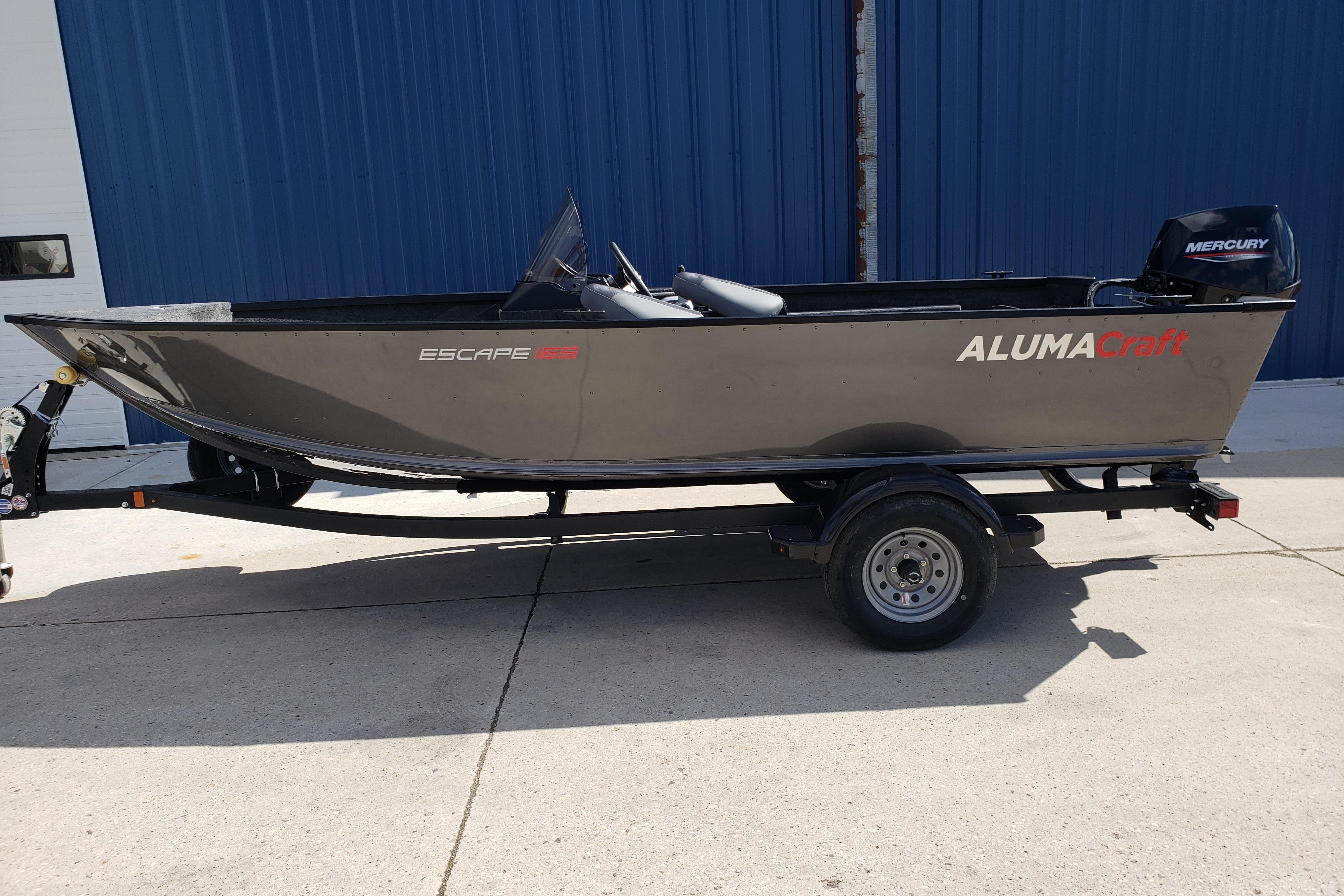 2026 Alumacraft Escape 165 CS boat on trailer, parked outdoors.
