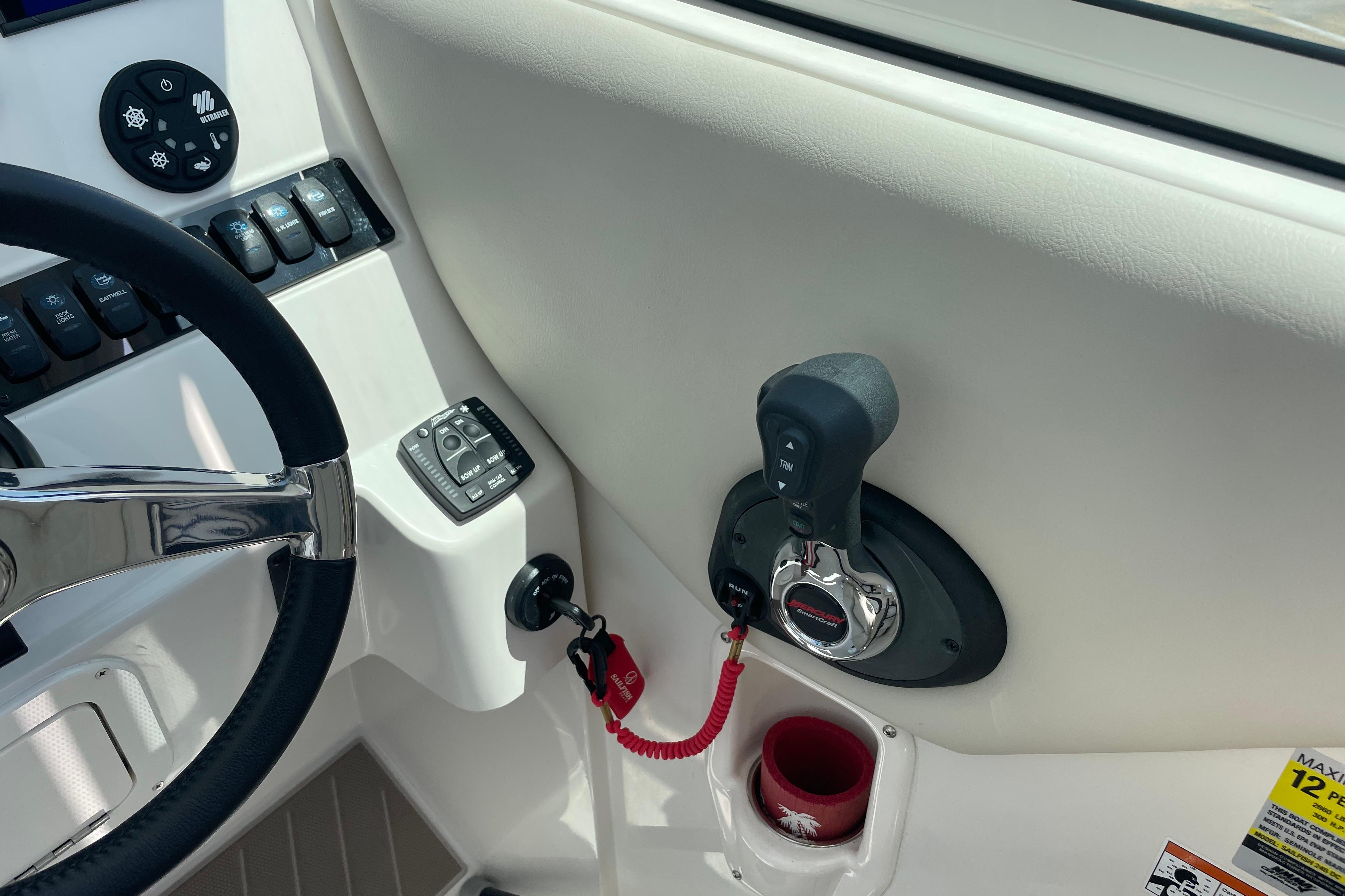 2022 Sailfish 245 DC boat dashboard with steering wheel and throttle controls.