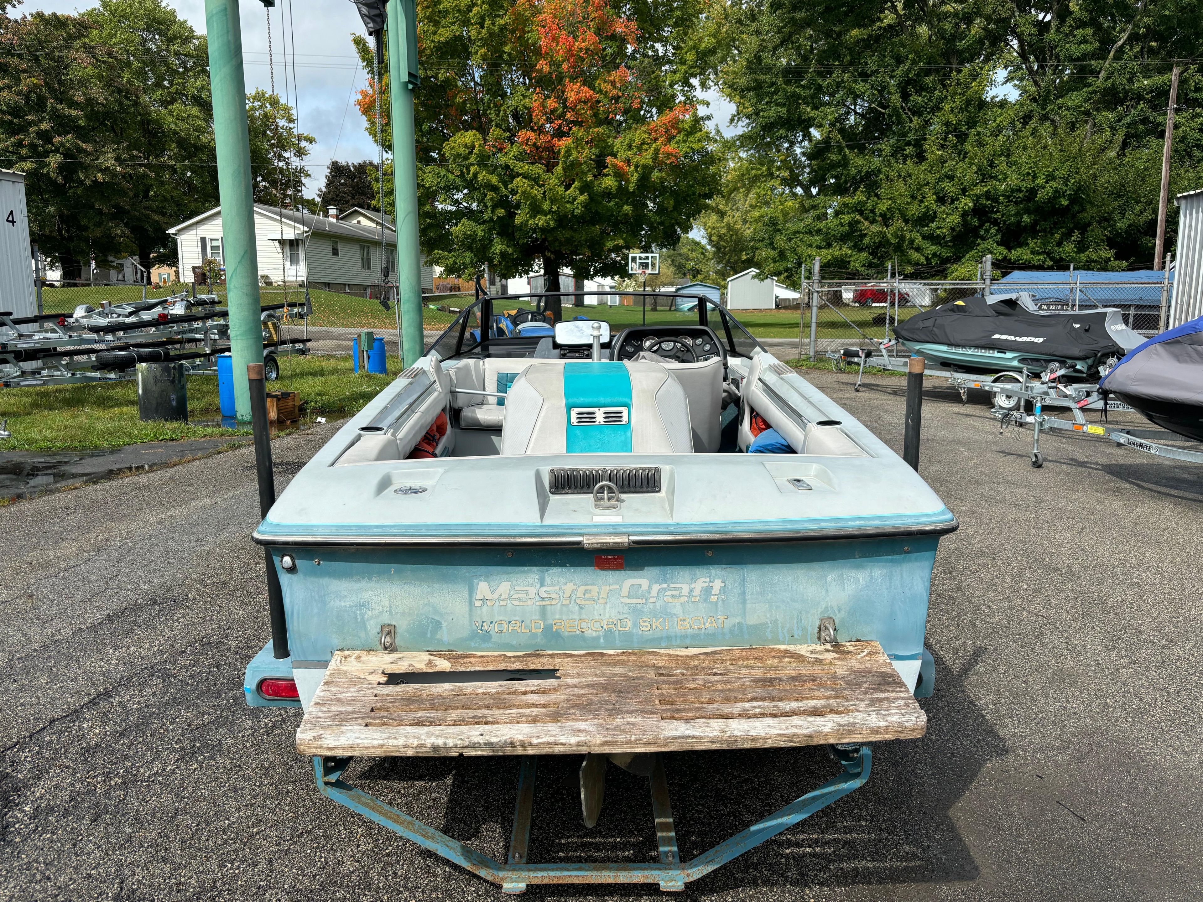 1989 MasterCraft ProStar 190 boat, rear view, parked outdoors on a sunny day.