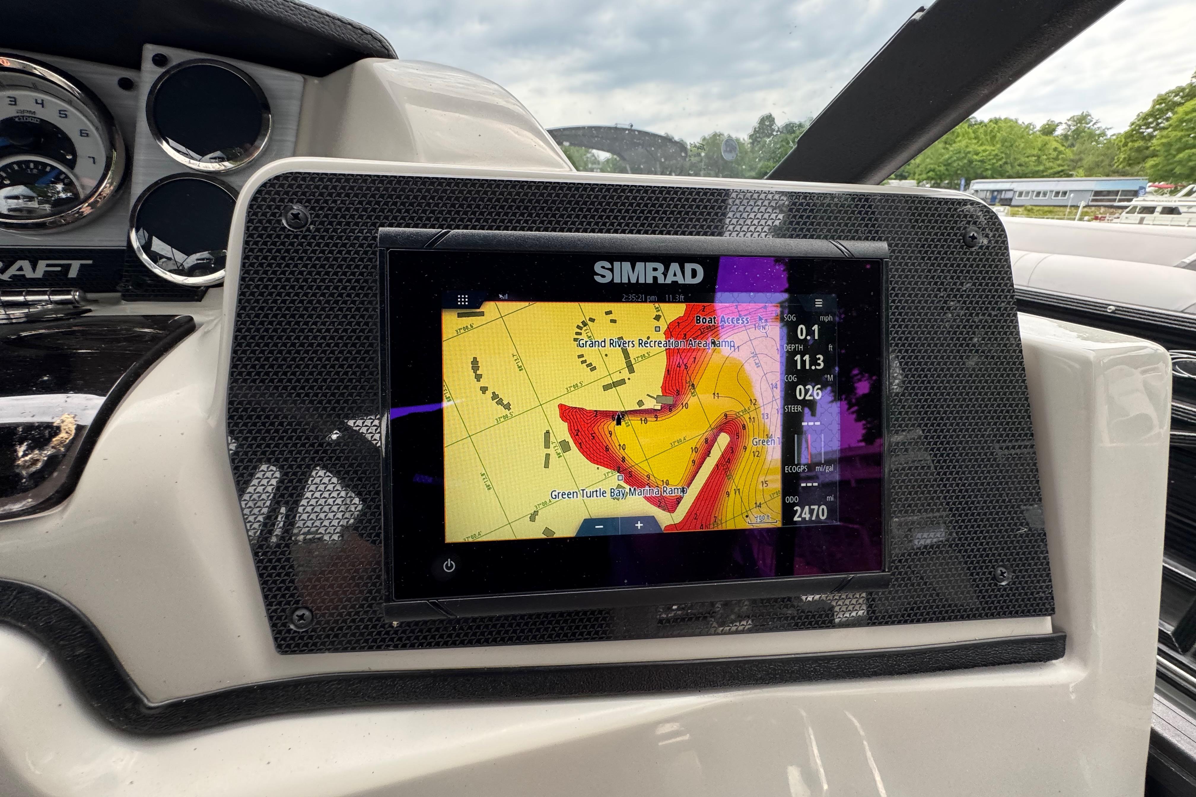 Simrad navigation display on 2023 Starcraft MX 25 DL DH boat dashboard, showing detailed map.