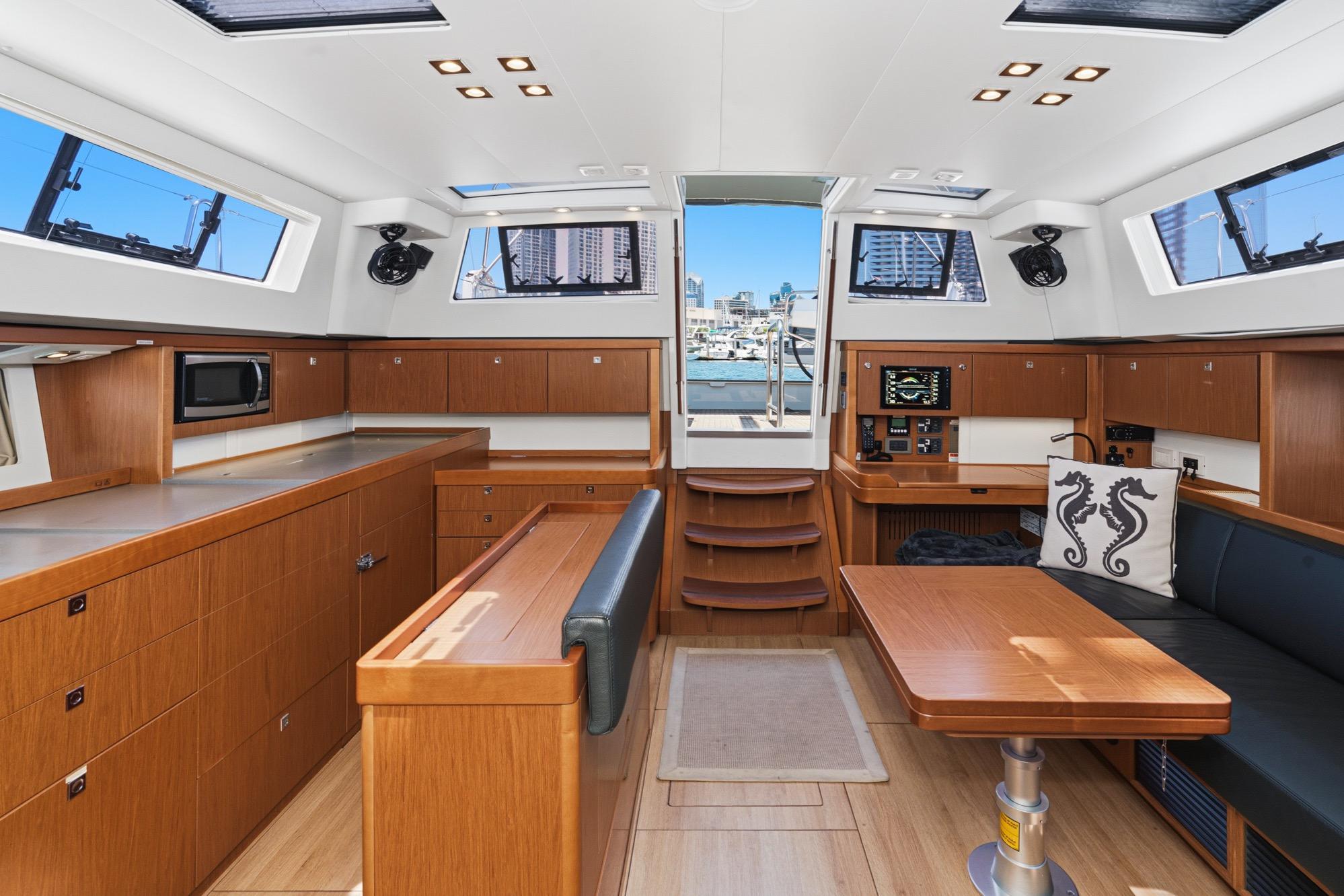 Luxurious interior of 2017 Beneteau Sense 50 yacht with modern wood finish and seating area.