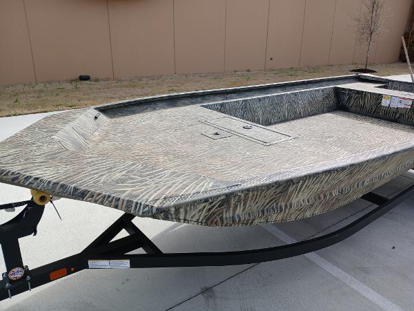 2025 Tracker GRIZZLY 1860 Utility boat on trailer, featuring a camouflage design.