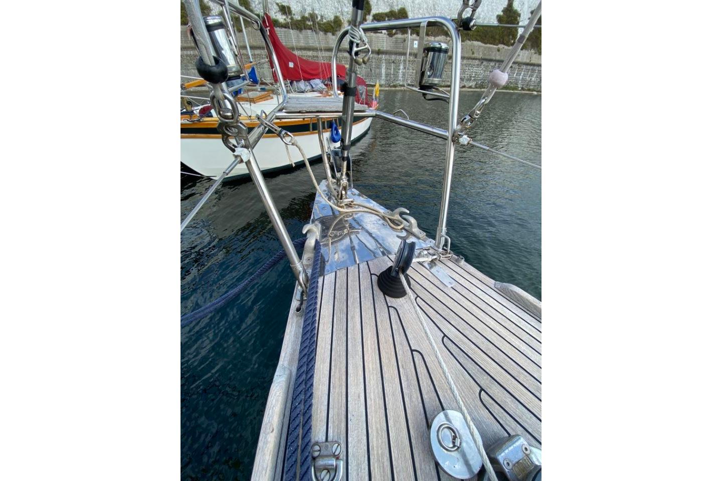 Deck view of a 1996 Nautor Swan 48 sailboat, showcasing teak wood and rigging details.