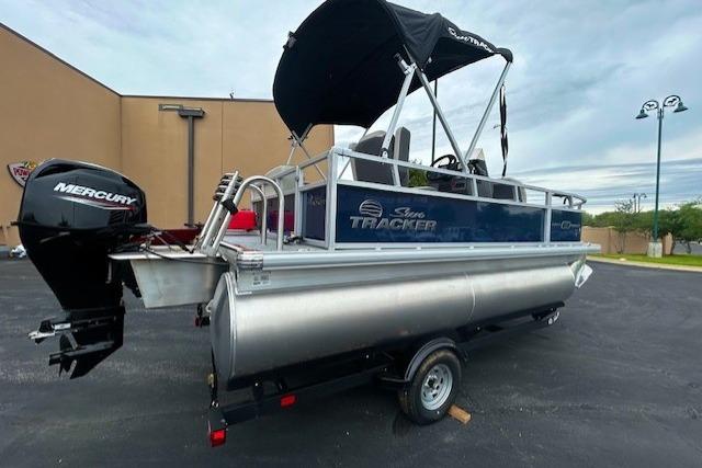 2026 Sun Tracker Bass Buggy 18 DLX pontoon boat with Mercury engine on trailer.